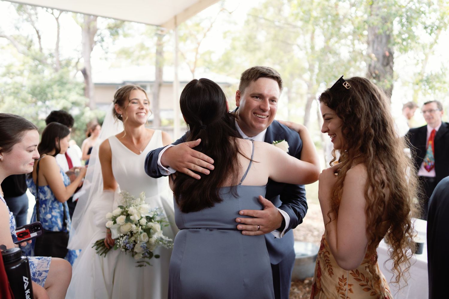 A sequence of emotional embraces and celebrations at a wedding reception.