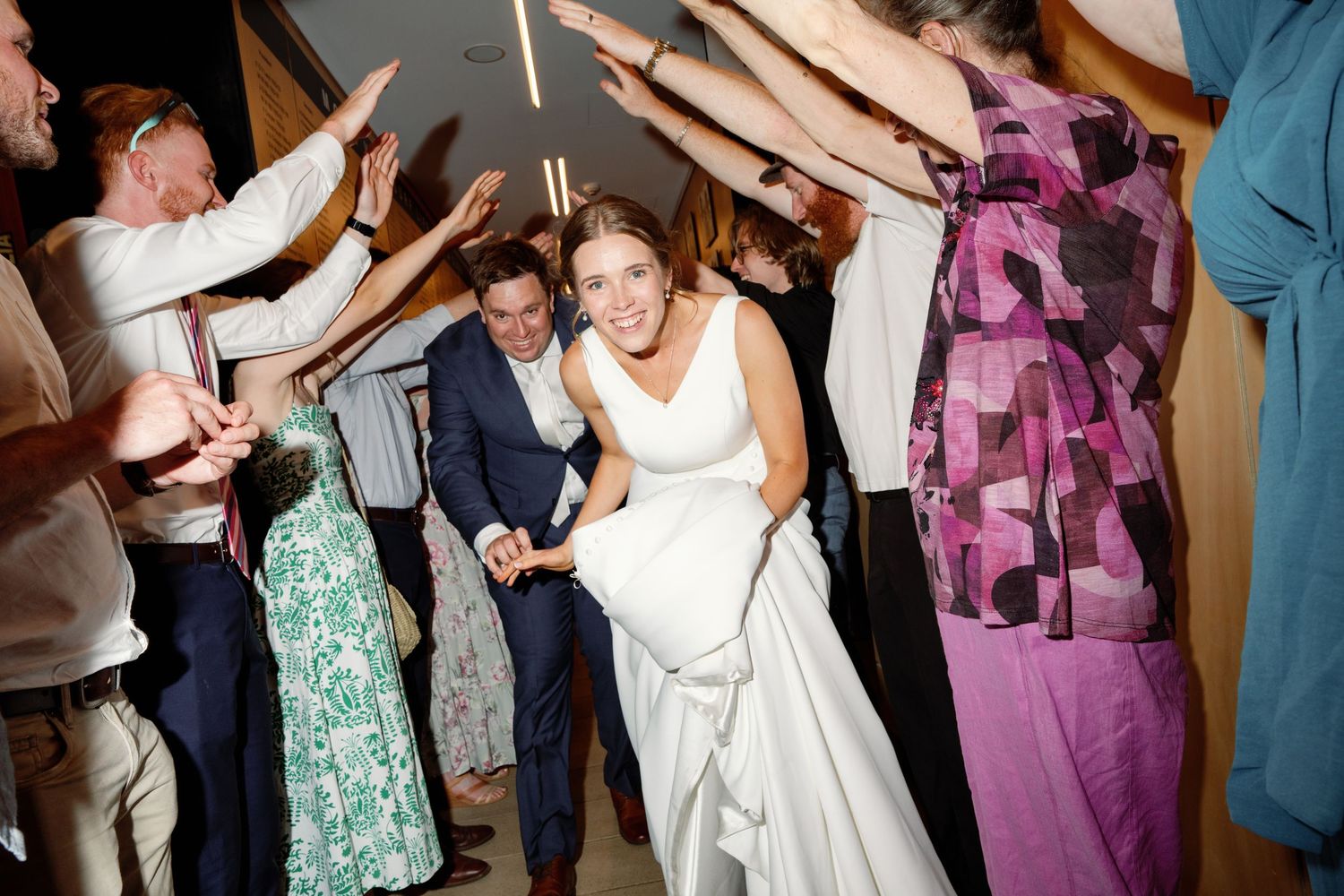 Wedding reception dance floor filled with guests celebrating and dancing.