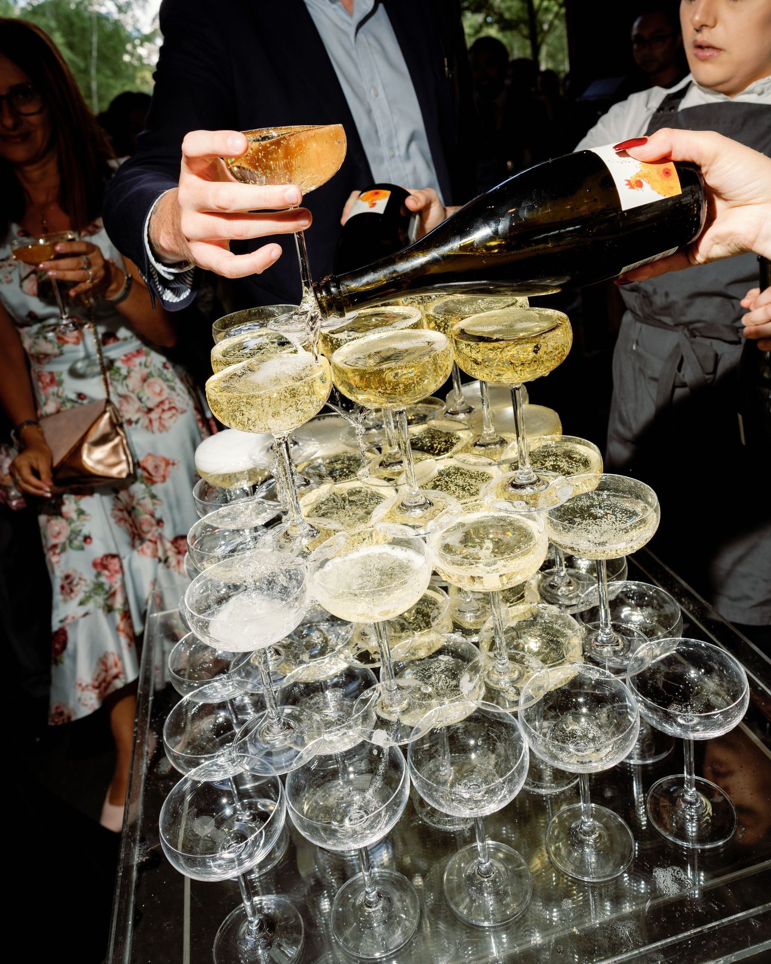 Champagne glasses arranged in elegant towers at an upscale event reception.