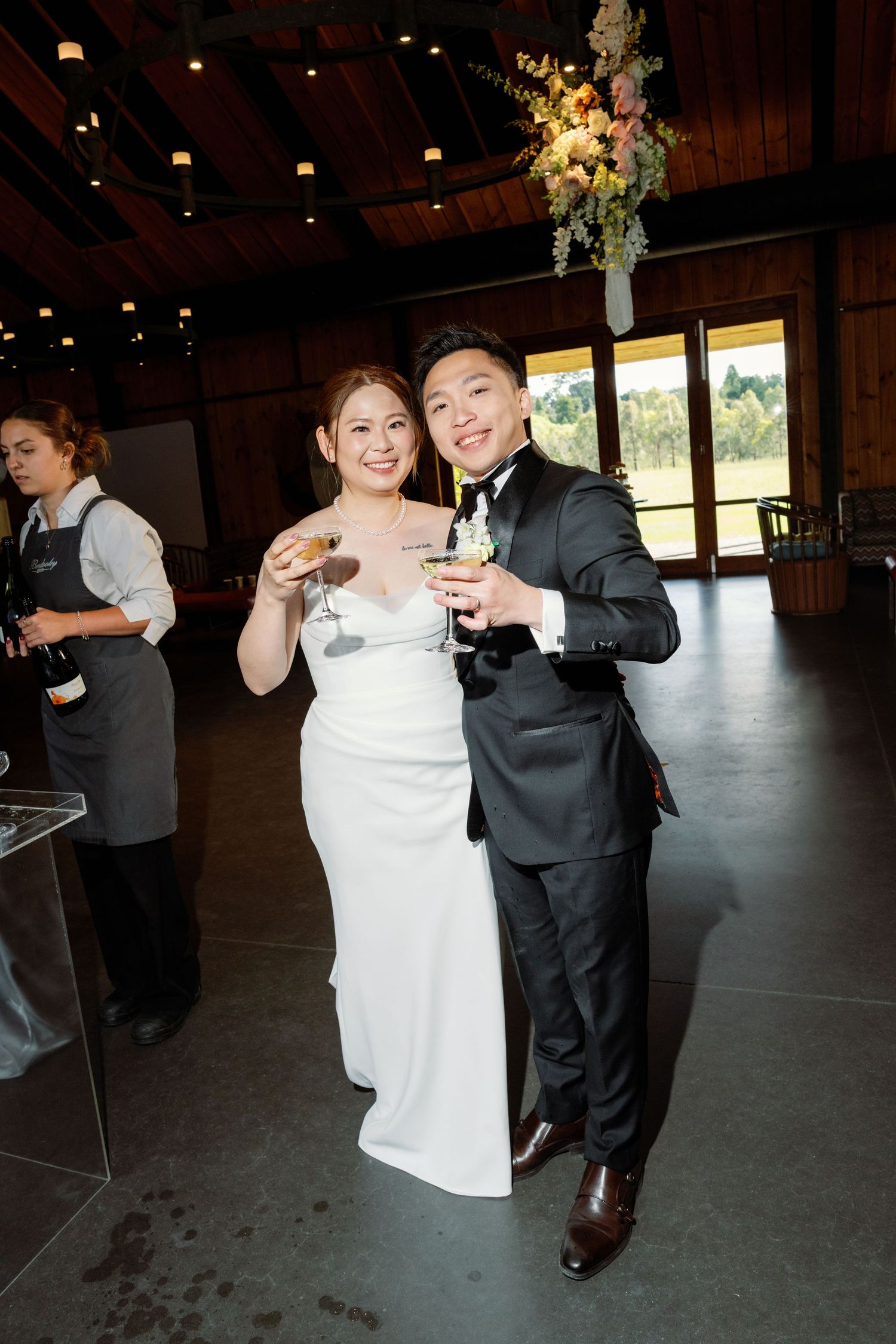 Couples dancing together at an indoor wedding reception in formal attire.