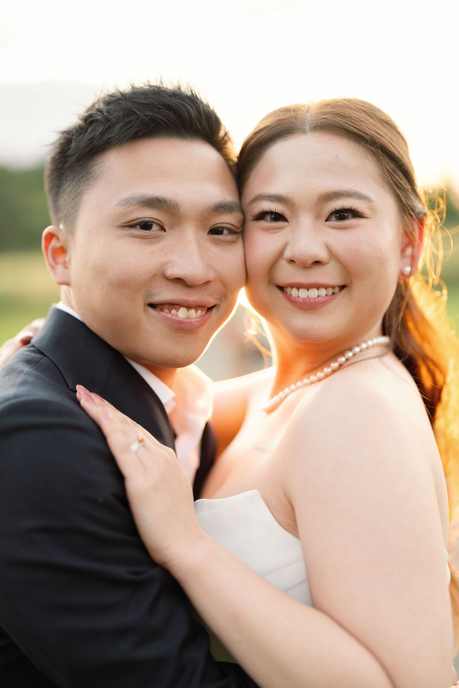 A couple sharing an intimate moment in golden sunlight.