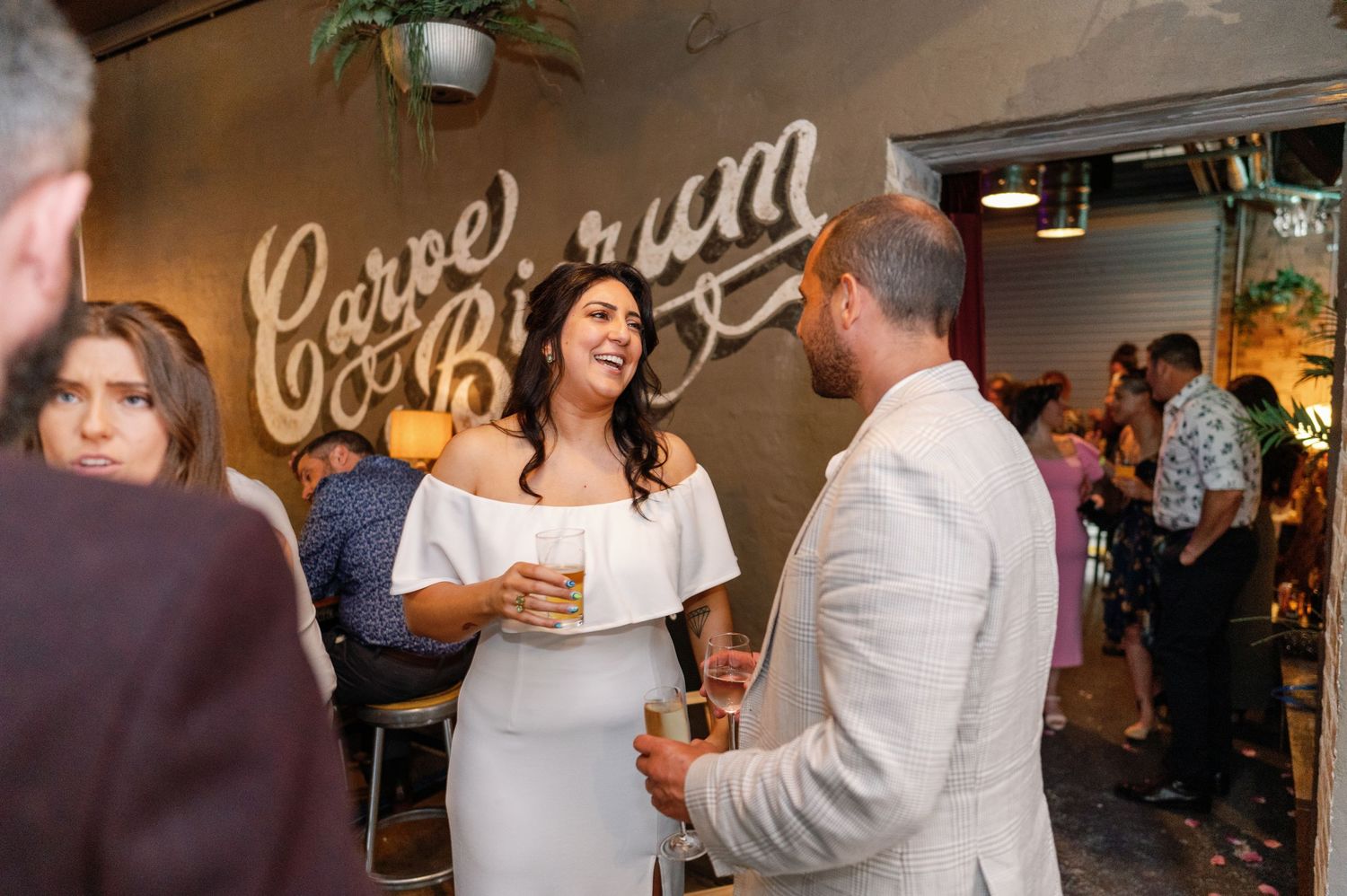 Lively bar scene with guests socializing in casual evening atmosphere.