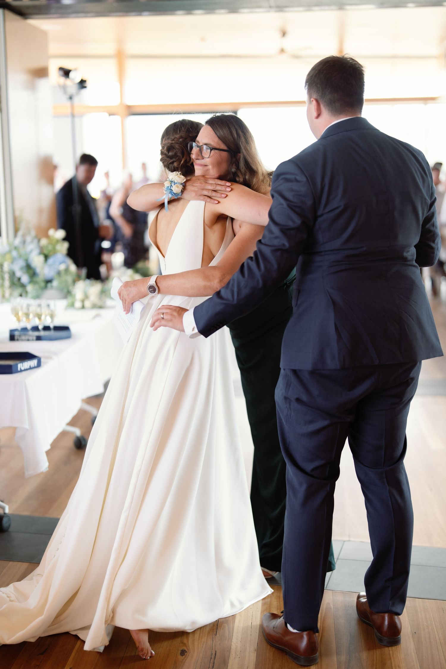 Wedding couple dancing in elegant reception venue with white dress swirling.