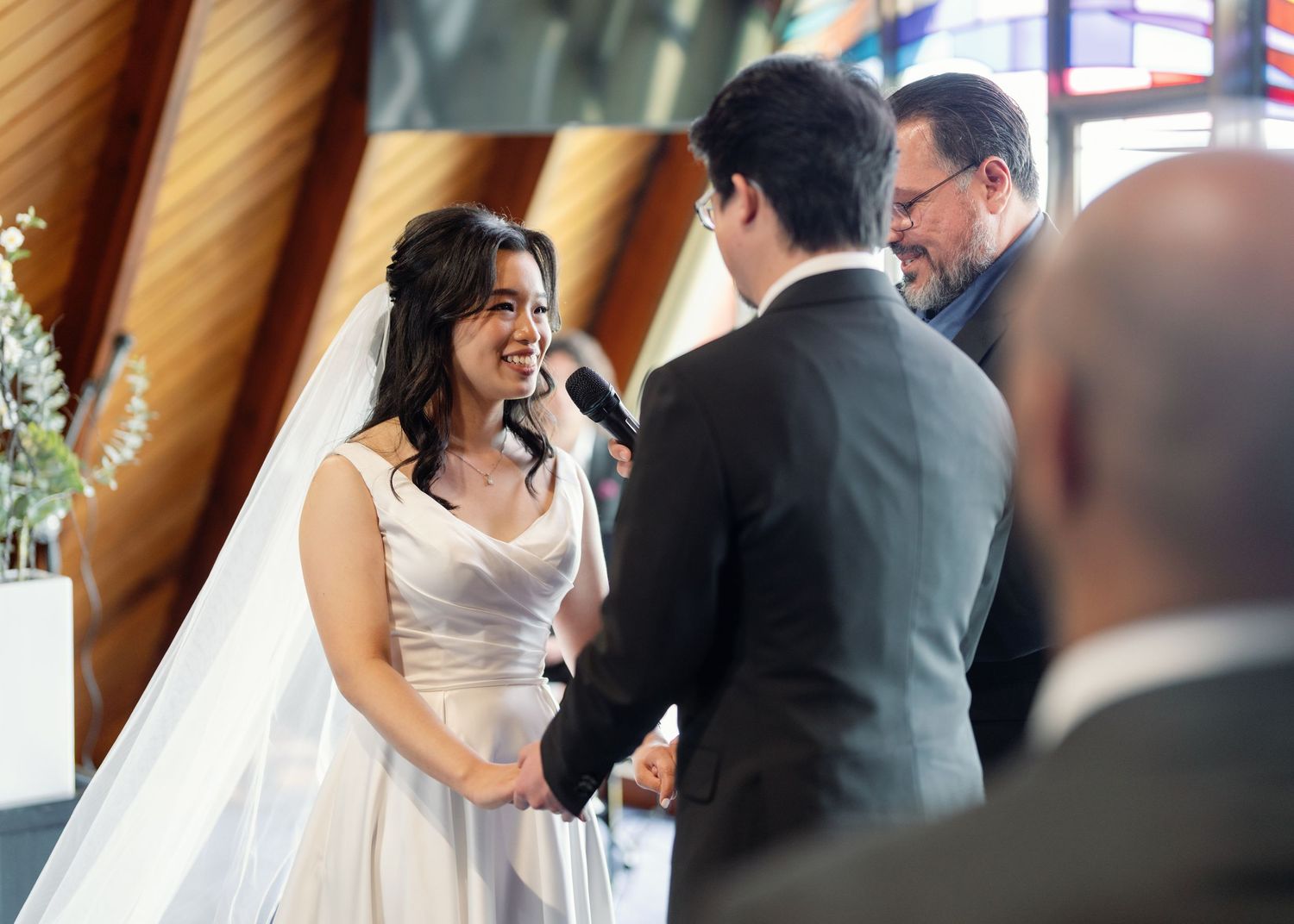 A bride and groom share their first dance together at an elegant indoor wedding reception.