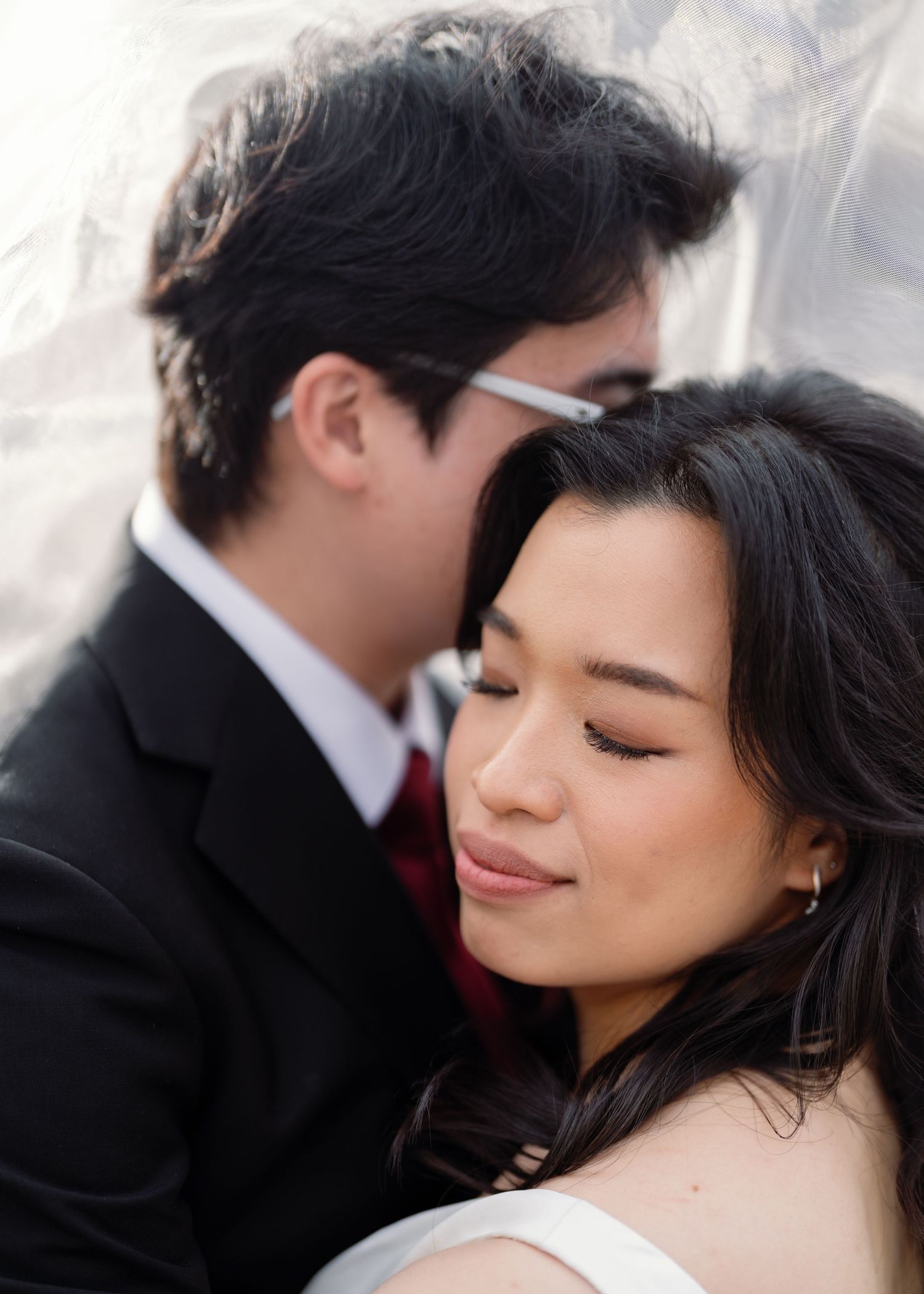 Romantic black and white portrait of couple sharing intimate moment.