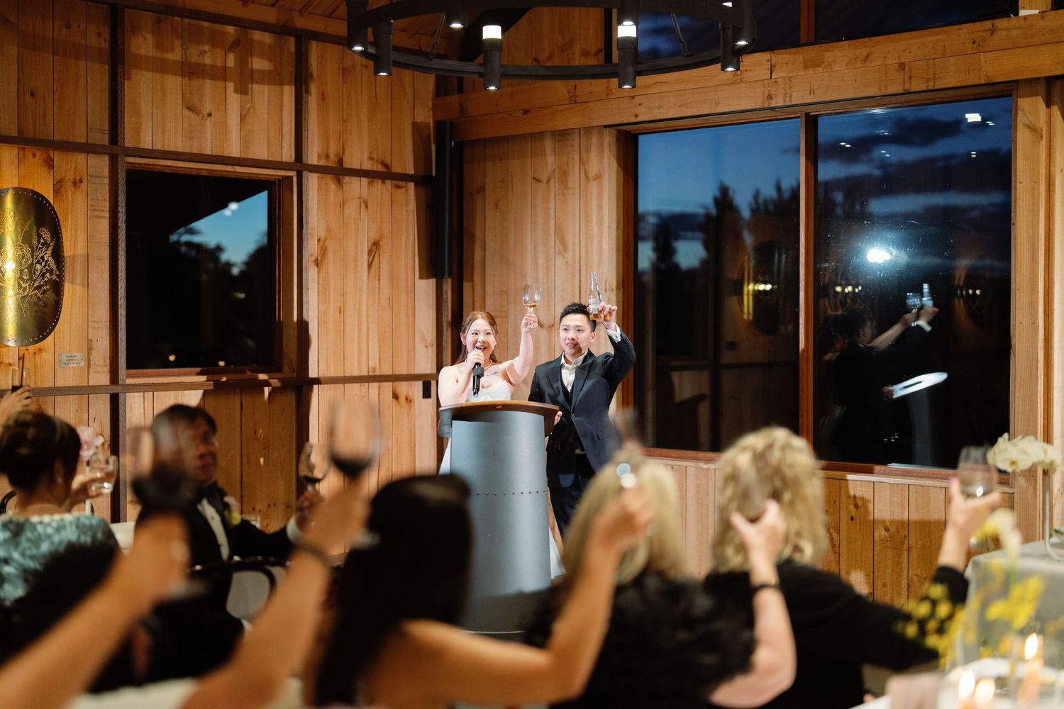Wedding reception venue with wooden paneled walls and ambient lighting.