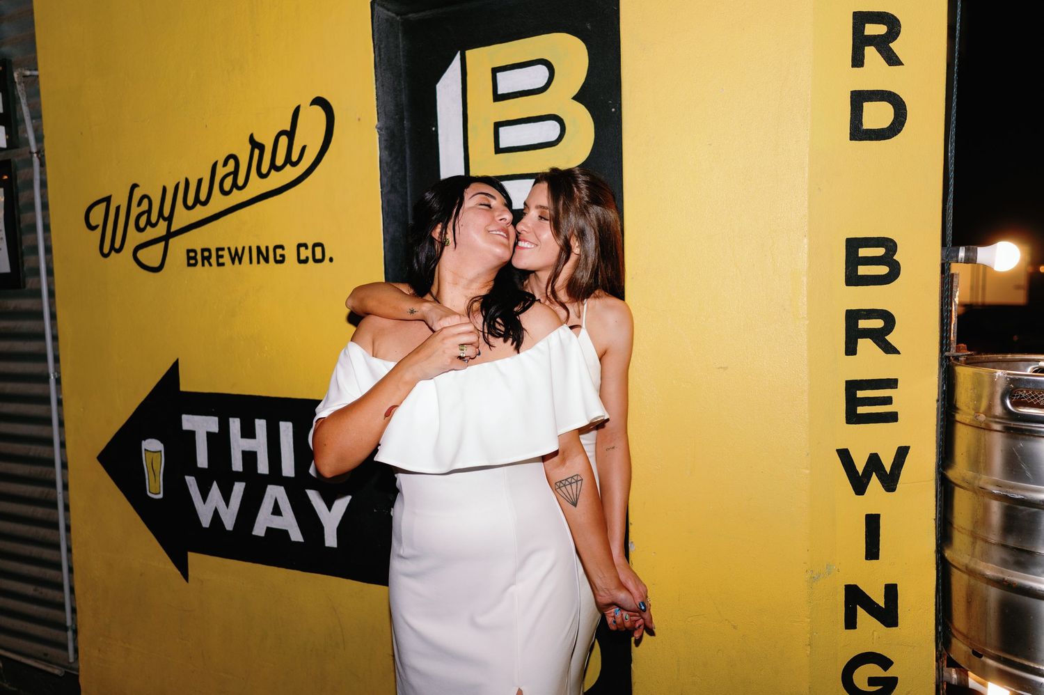 Industrial brewery space with yellow walls and company signage visible.