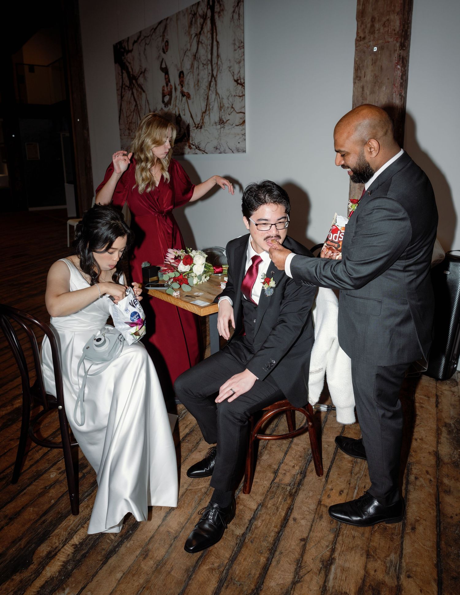 Wedding guests and newlyweds share a candid moment during reception celebrations.