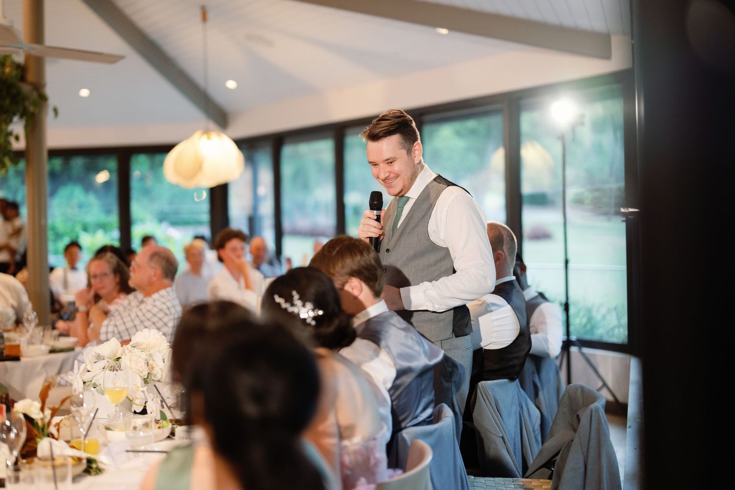 Wedding reception candid moments captured during speeches and toasts.
