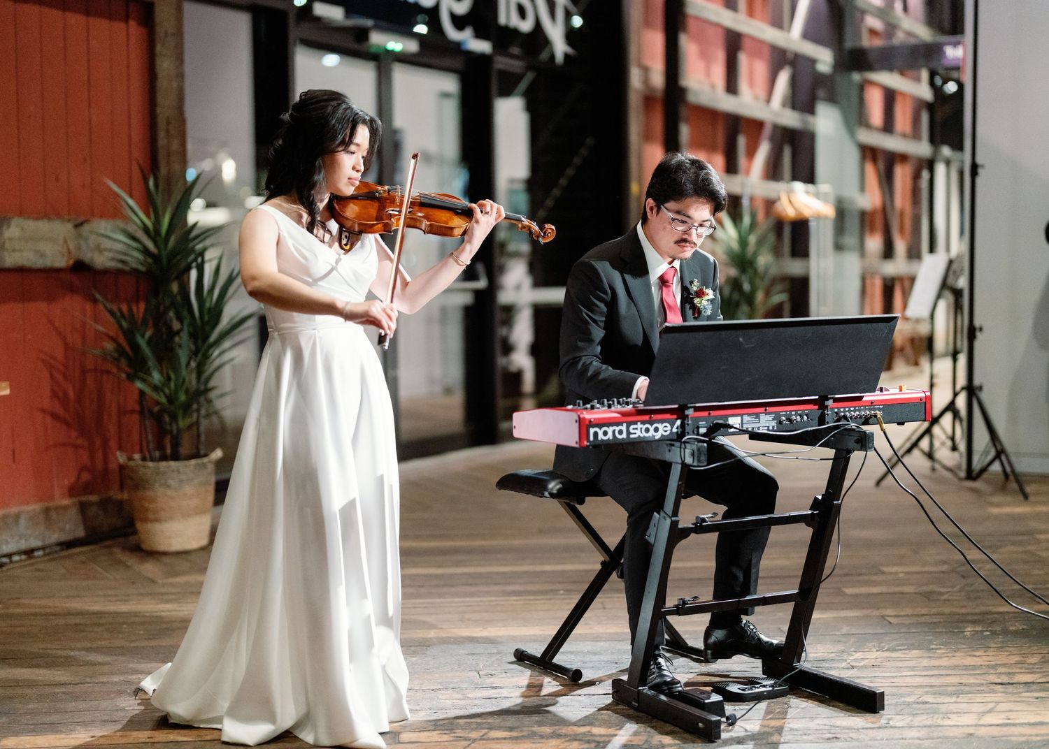 Musical instruments and performance equipment set up on a brick-lined outdoor patio.