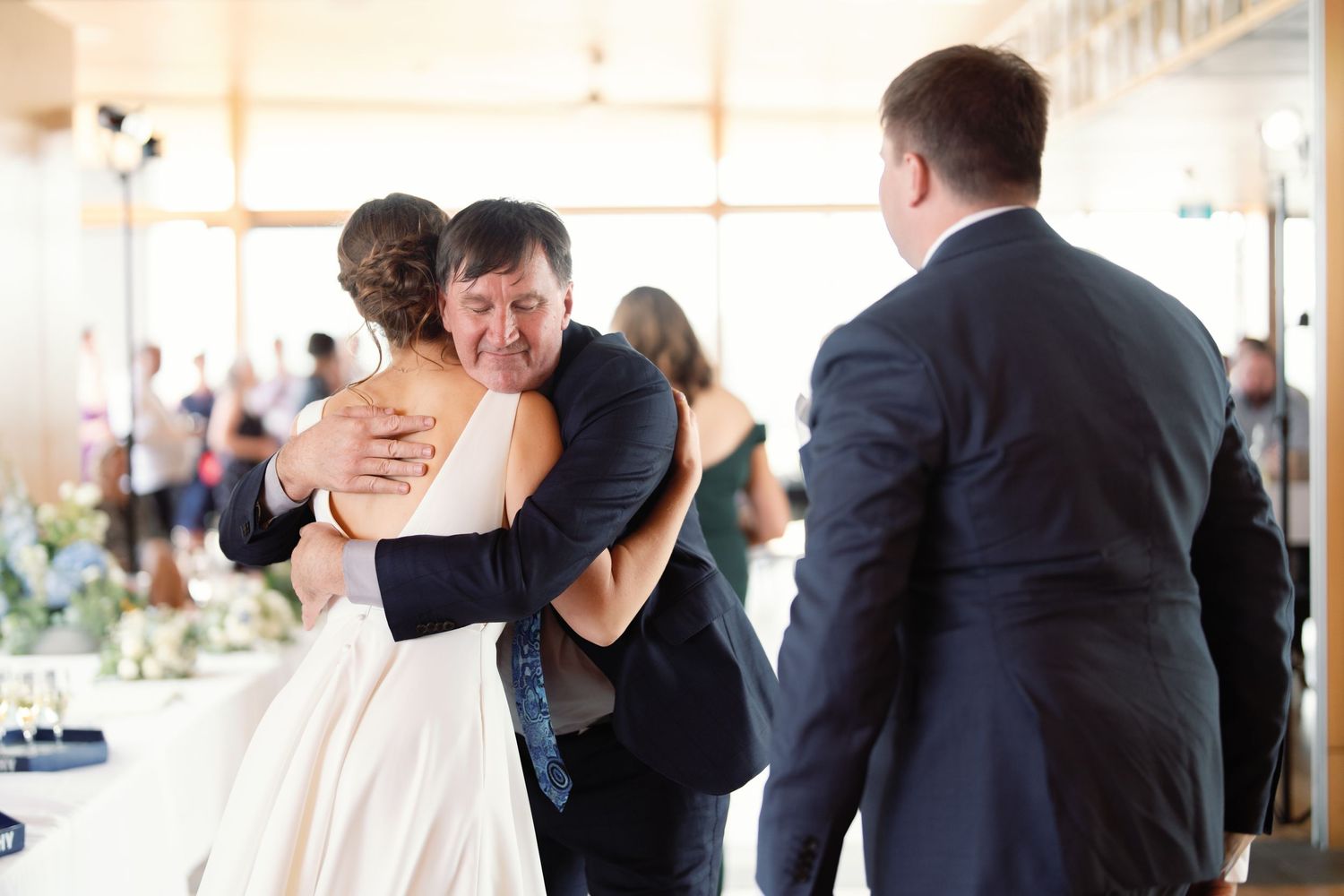 Indoor wedding reception venue with guests mingling.