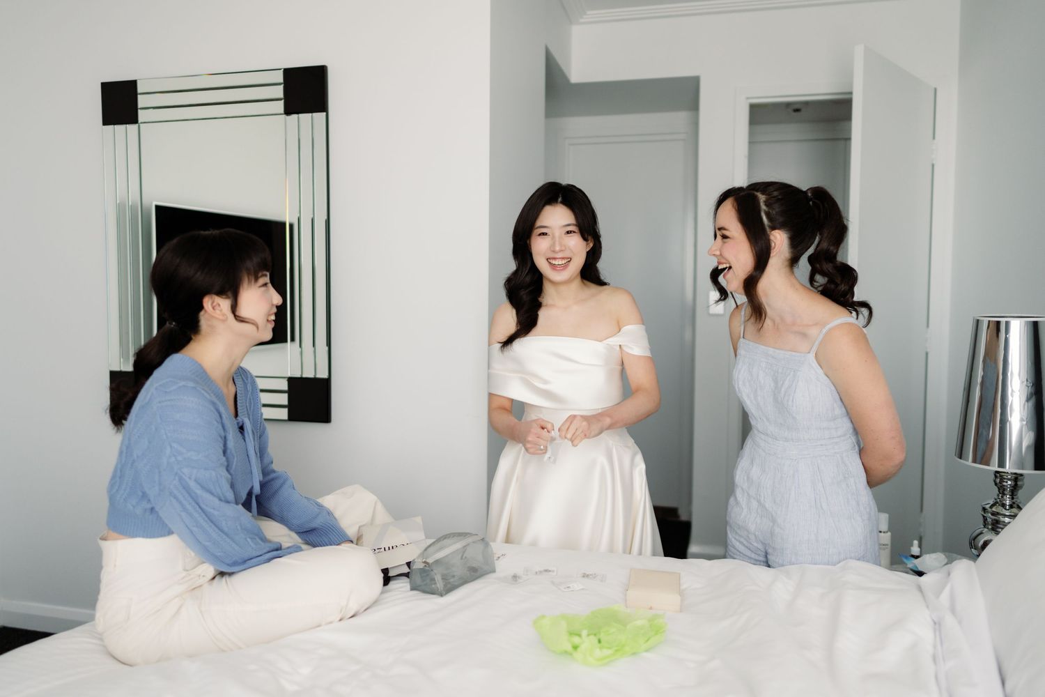 A series of black and white photos showing a person in a white dress and another in a blue shirt in a modern interior space.