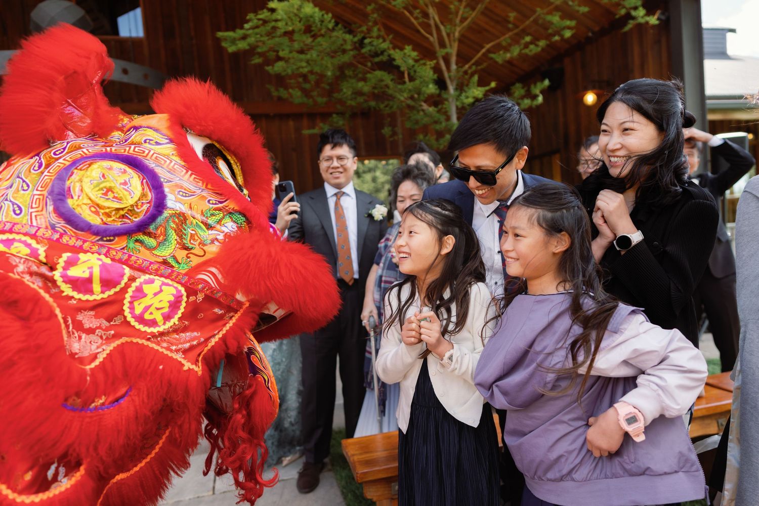 Traditional Chinese lion dance performance entertains wedding guests at reception.
