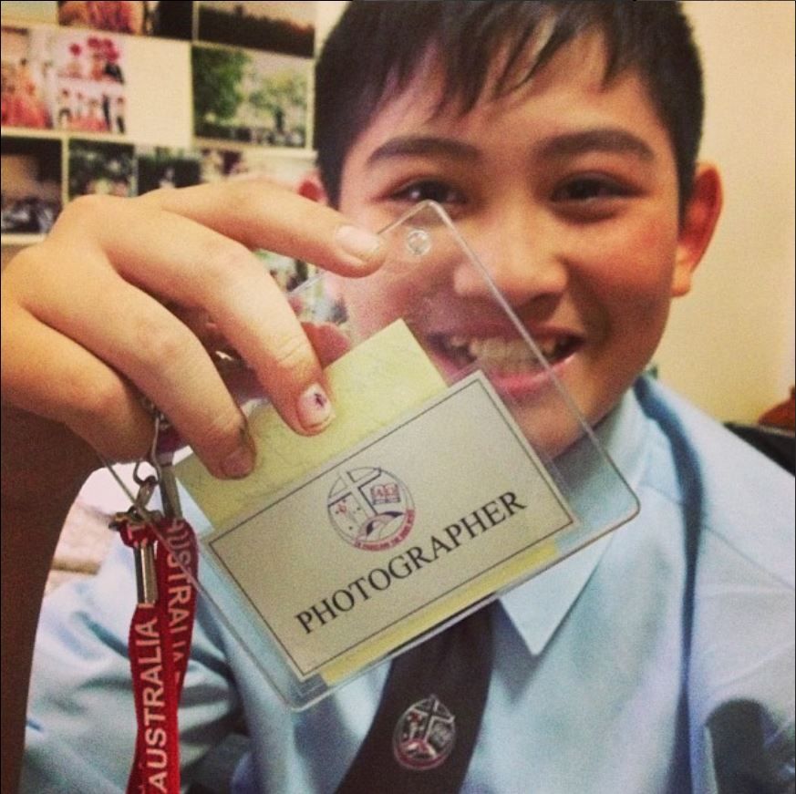 Someone holding up a photographer identification badge and lanyard.