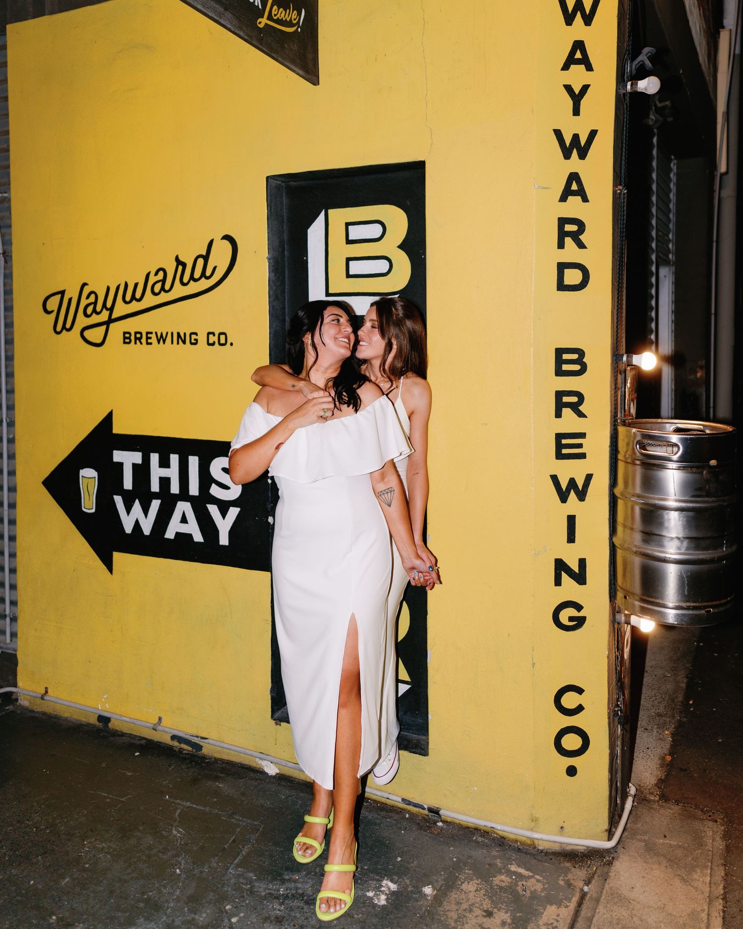 Yellow wall with 'Wayward Brewing Co.' signage and directional arrow pointing left.