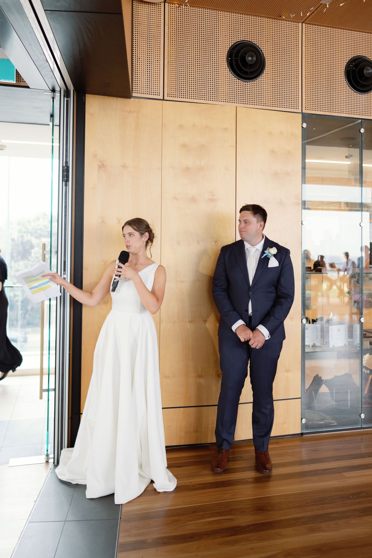 Fun wedding photo sequence showing playful poses against modern interior walls.