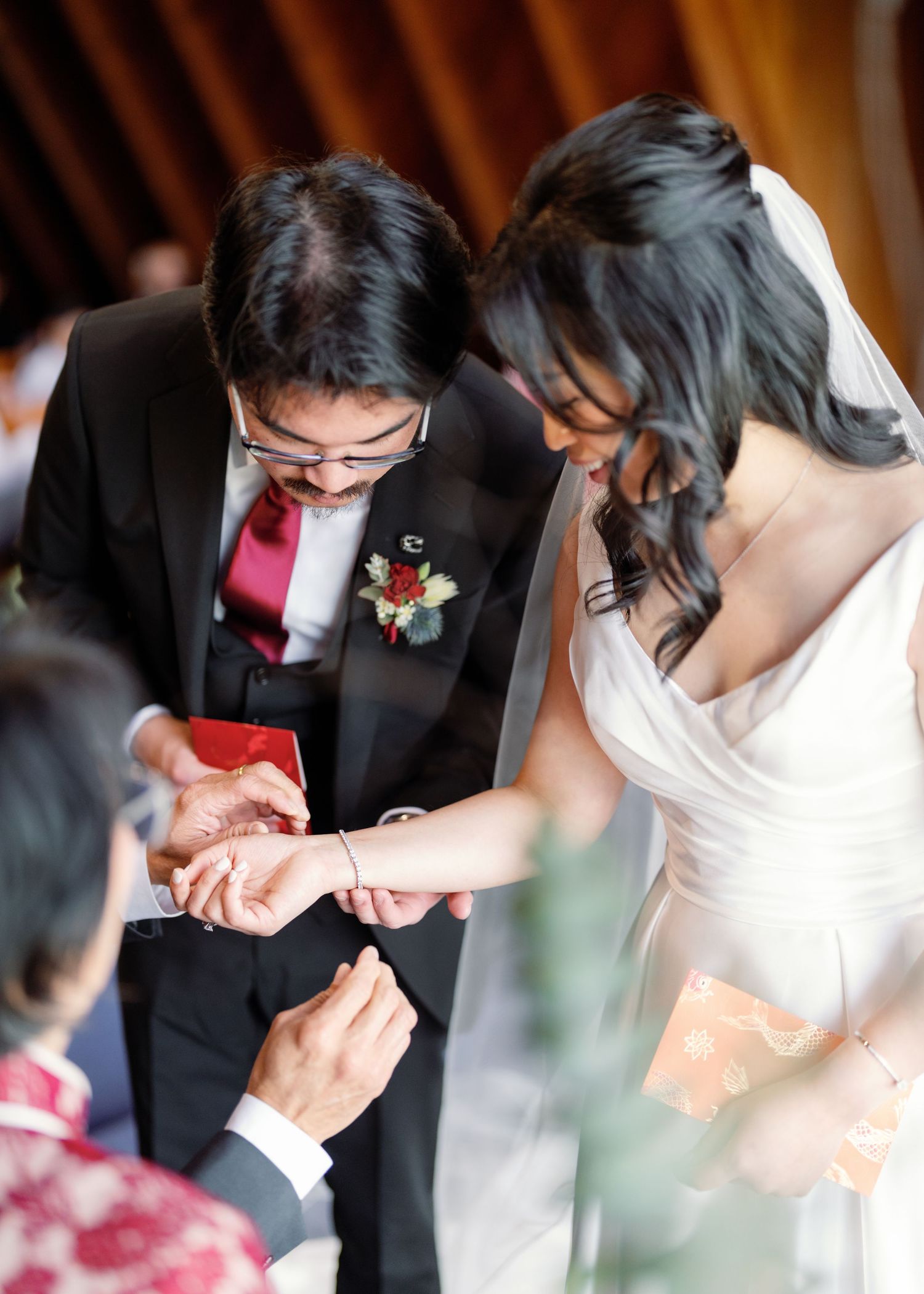 Close-up shot of ring exchange during wedding ceremony with hands in focus.