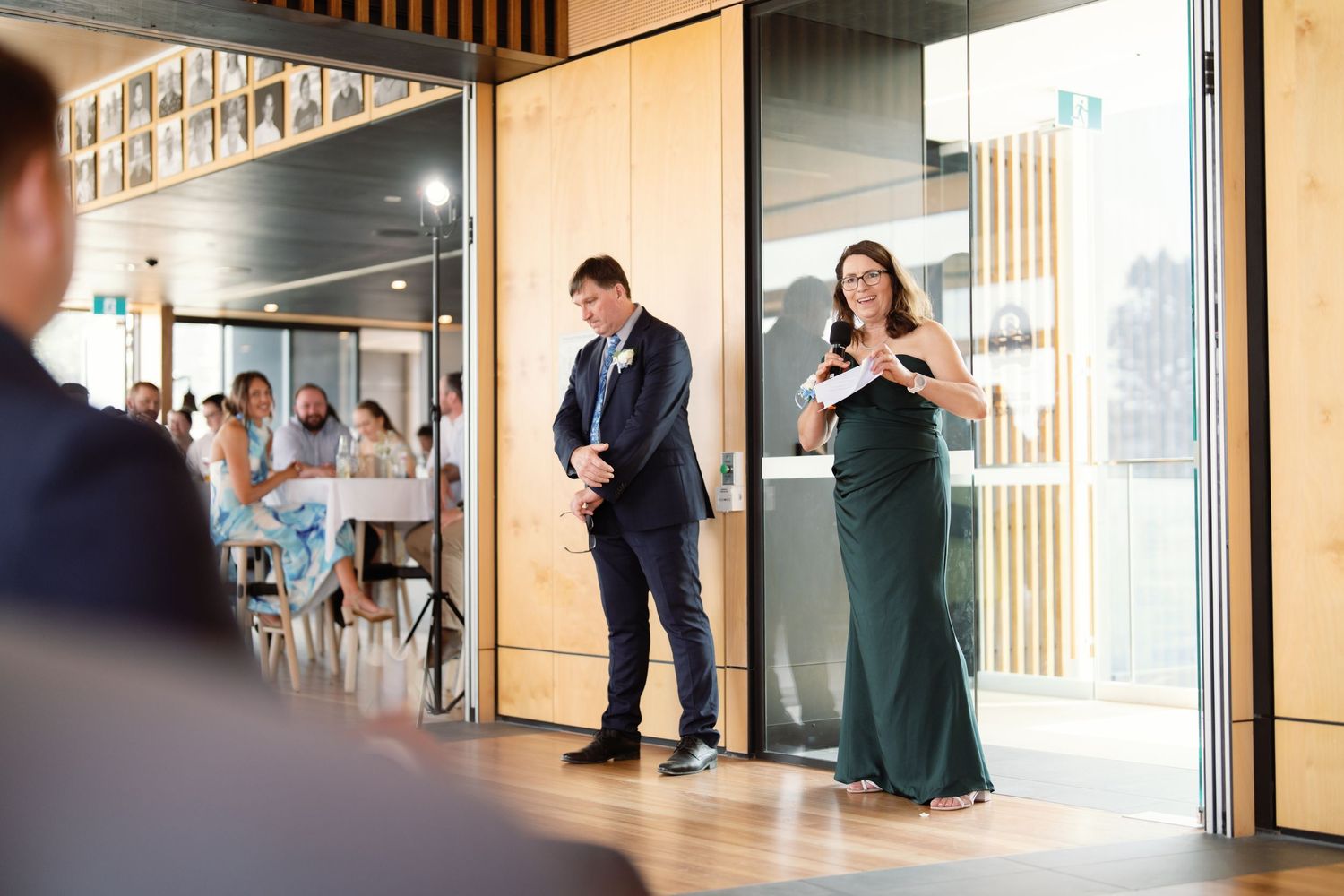 Interior hallway view of modern building with glass walls and wood accents.