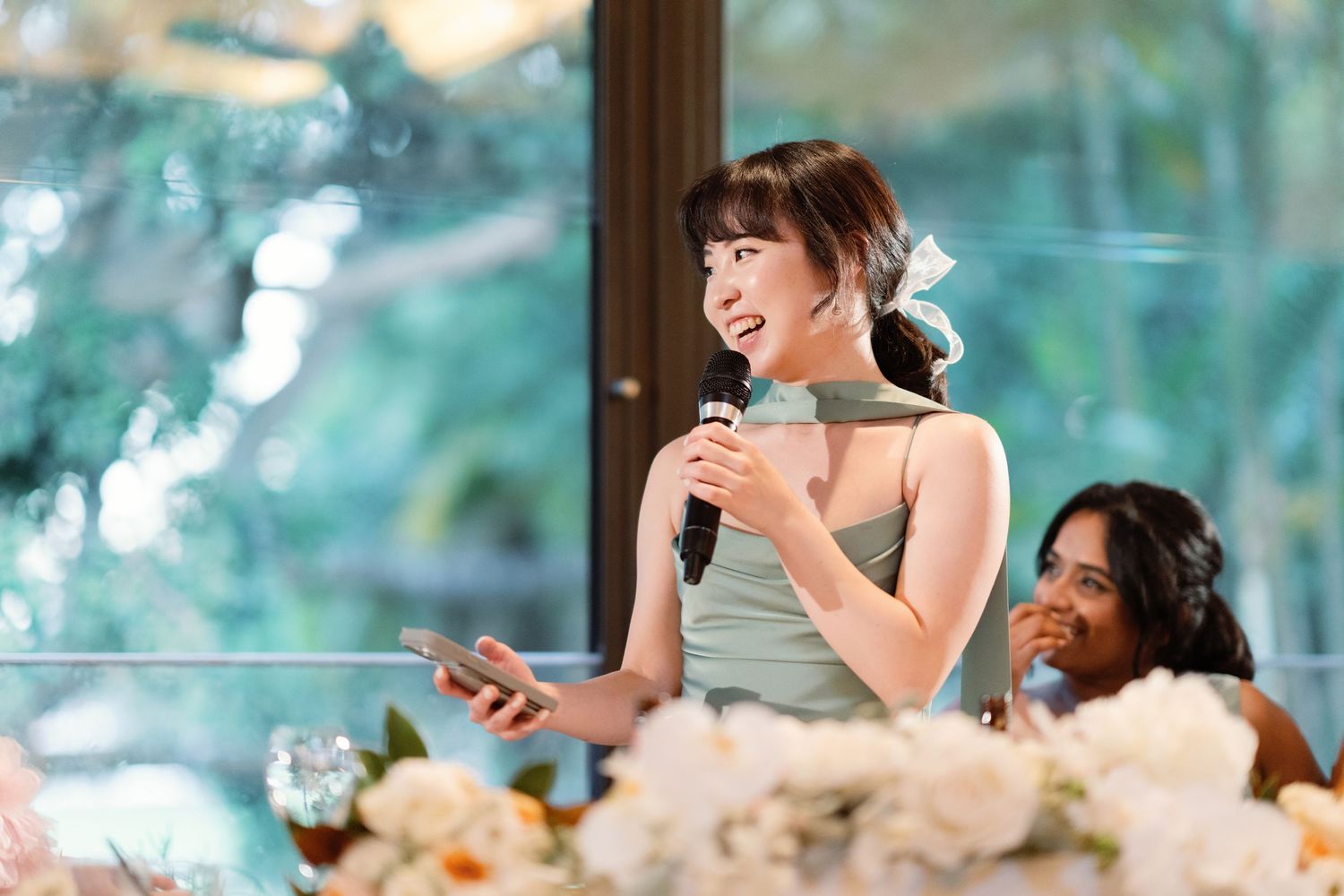 Candid moments of laughter and joy during wedding reception speeches.