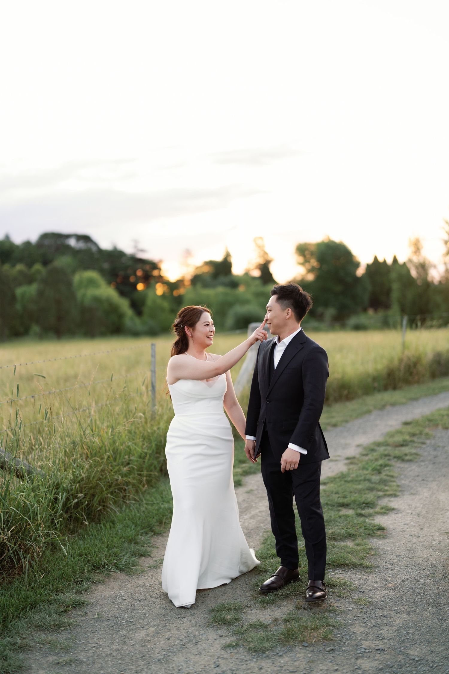 A wedding photo sequence of a couple posing playfully on a dirt path at sunset.