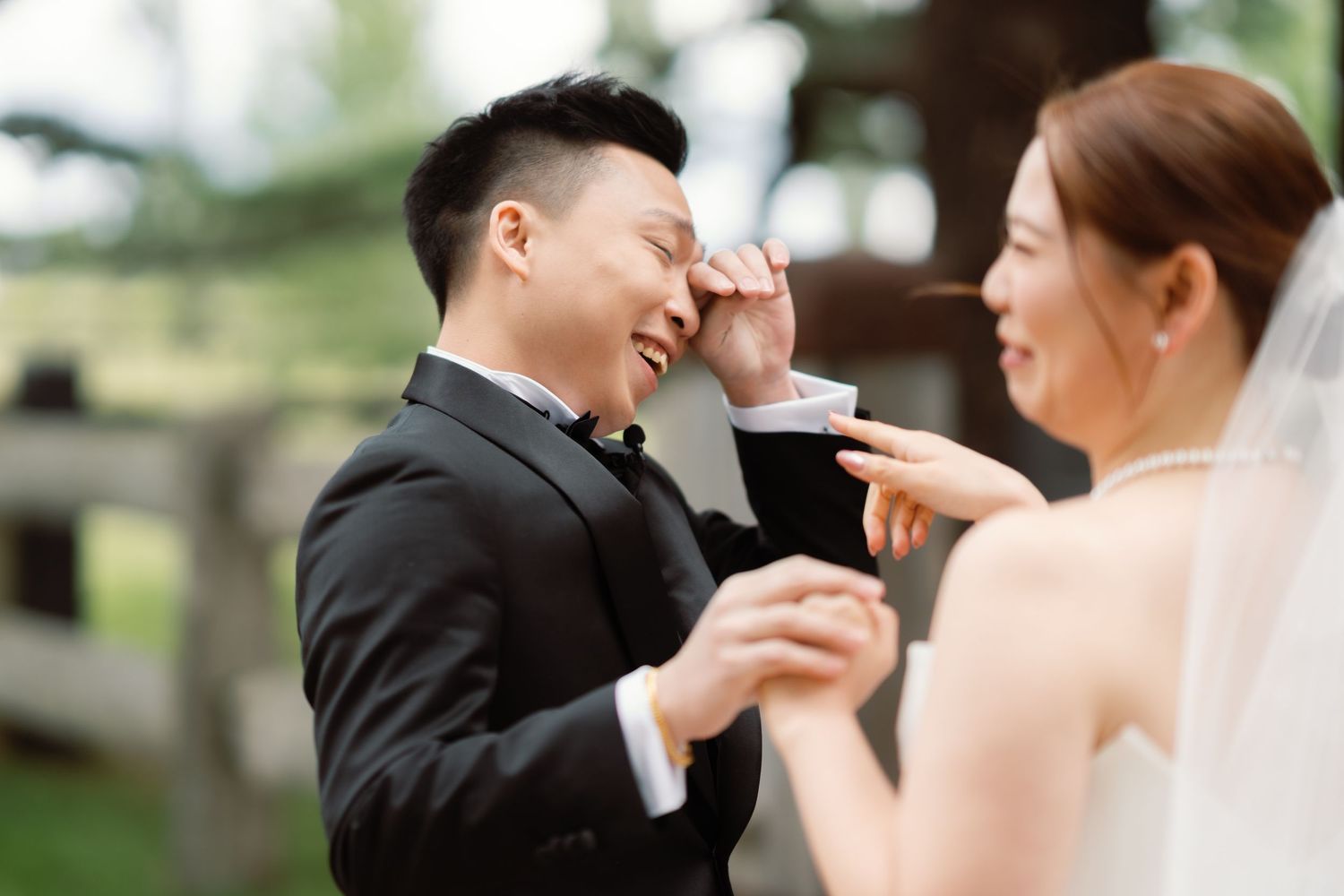 A couple shares an intimate moment during their wedding photoshoot in a natural outdoor setting.