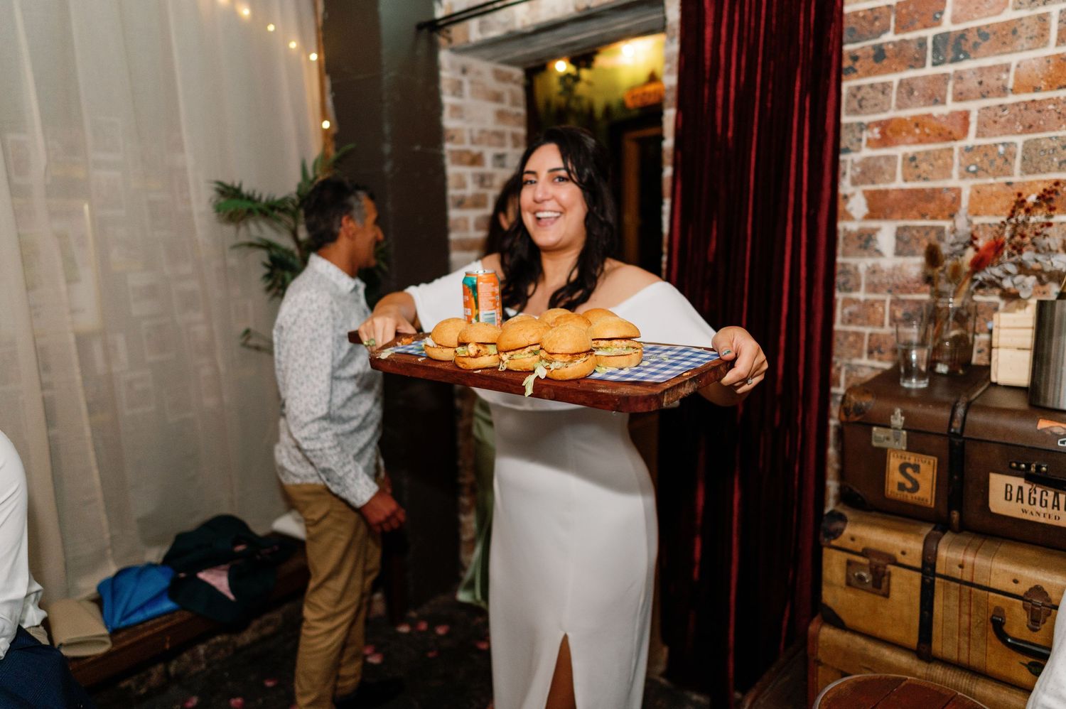 Industrial-style venue with exposed brick walls and string lights creating warm ambiance.