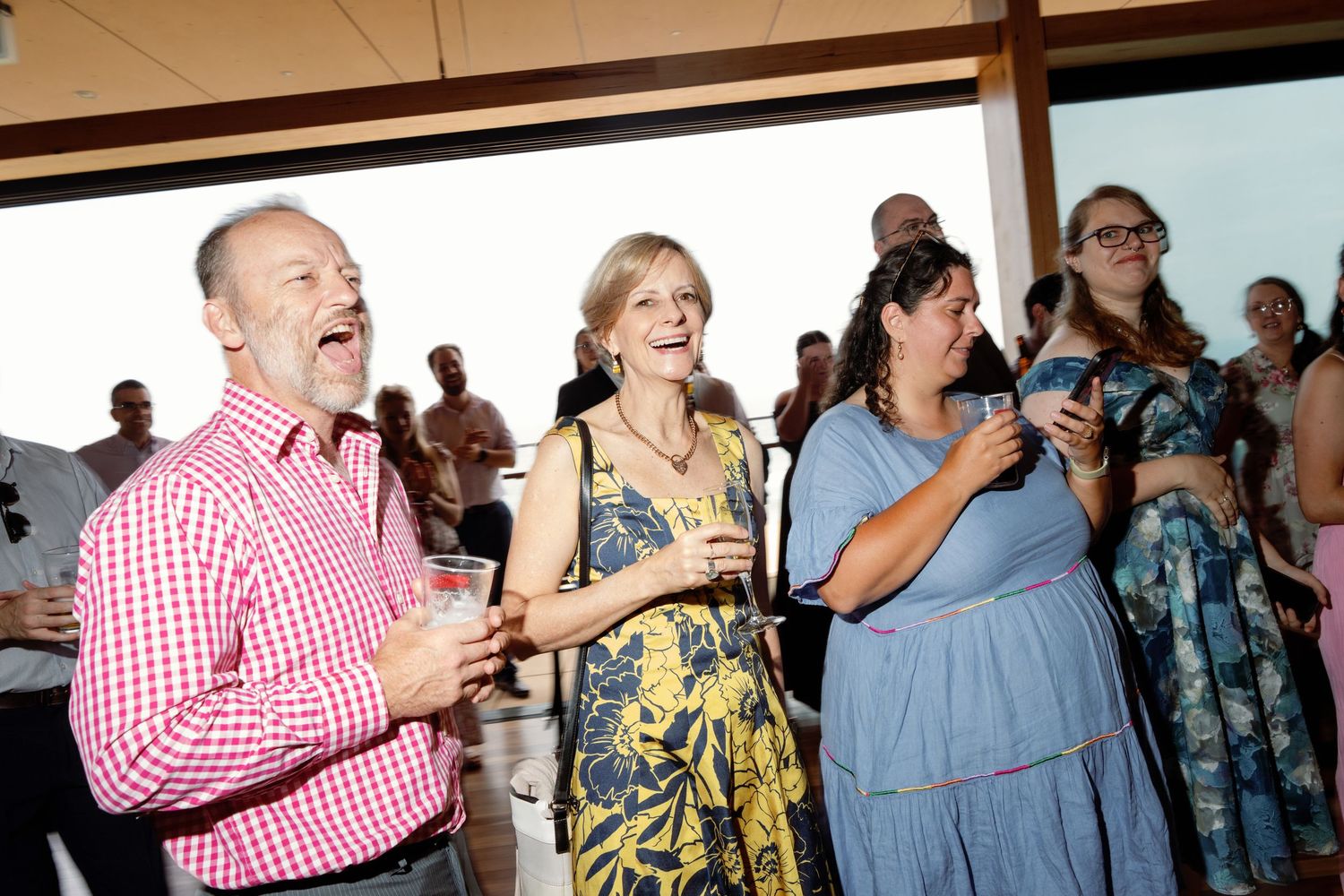 Wedding reception guests dancing and celebrating in casual attire.