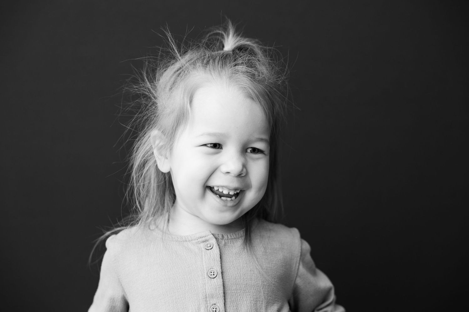 Black and white portrait series showing expressive emotions from laughter to thoughtful poses in dramatic lighting.