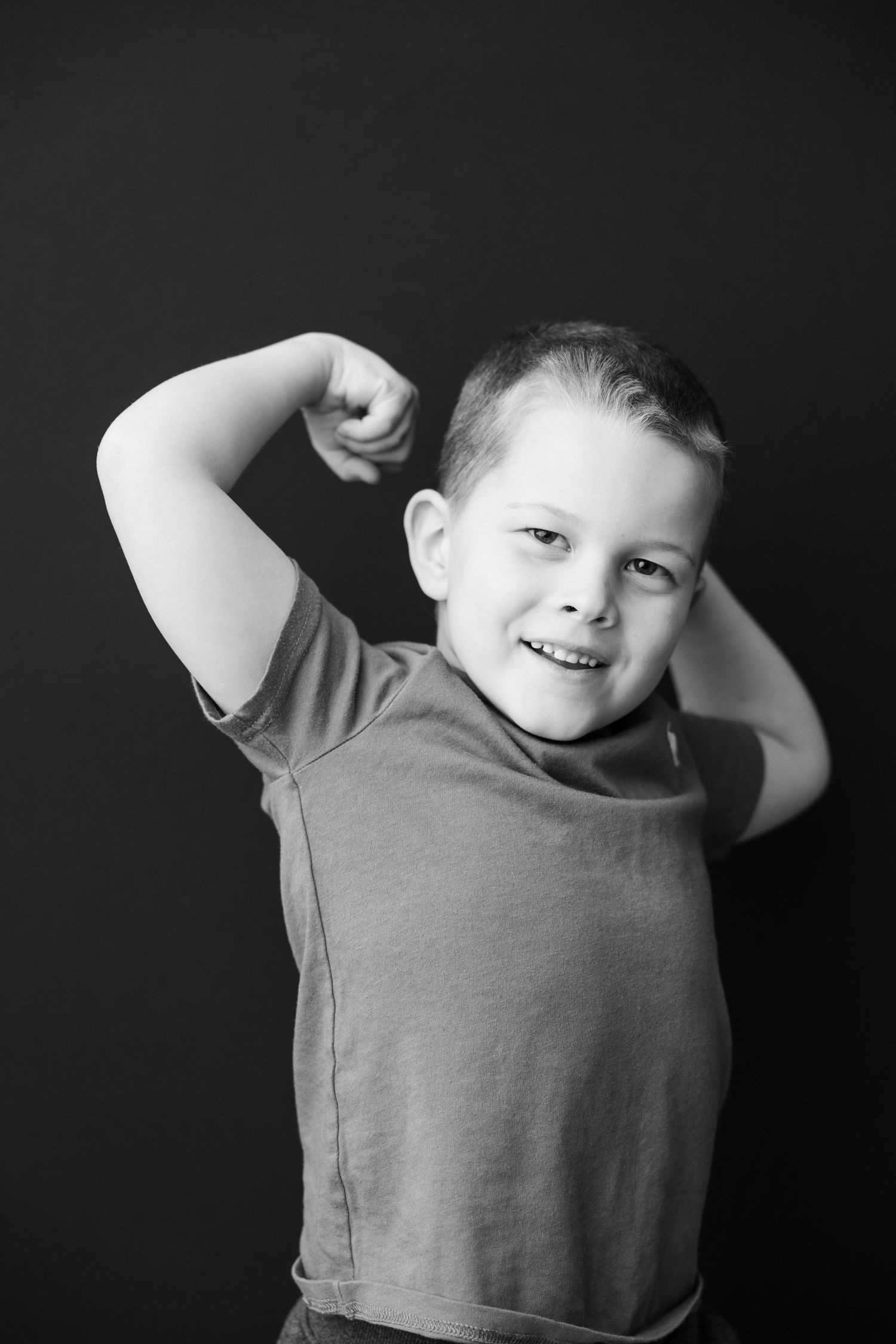 A series of black and white photos showing a young child lifting up their shirt to show their stomach.