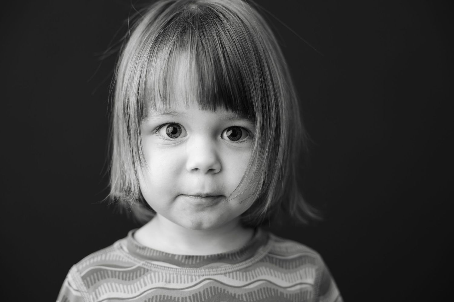 Six black and white portraits showcase endearing expressions that capture childhood innocence through candid moments.