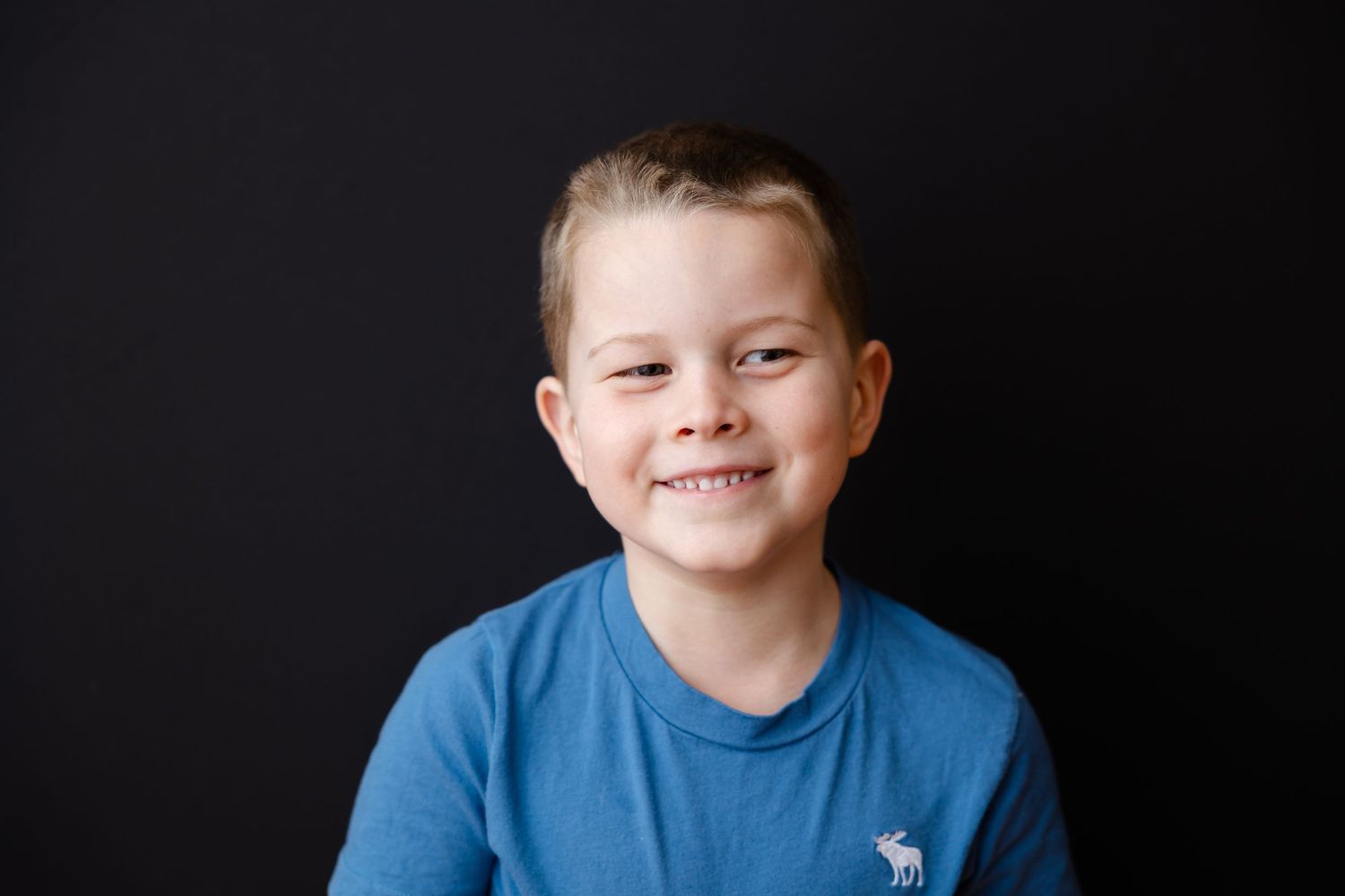 Multiple photos of someone wearing a blue shirt shown from different angles against a black background.