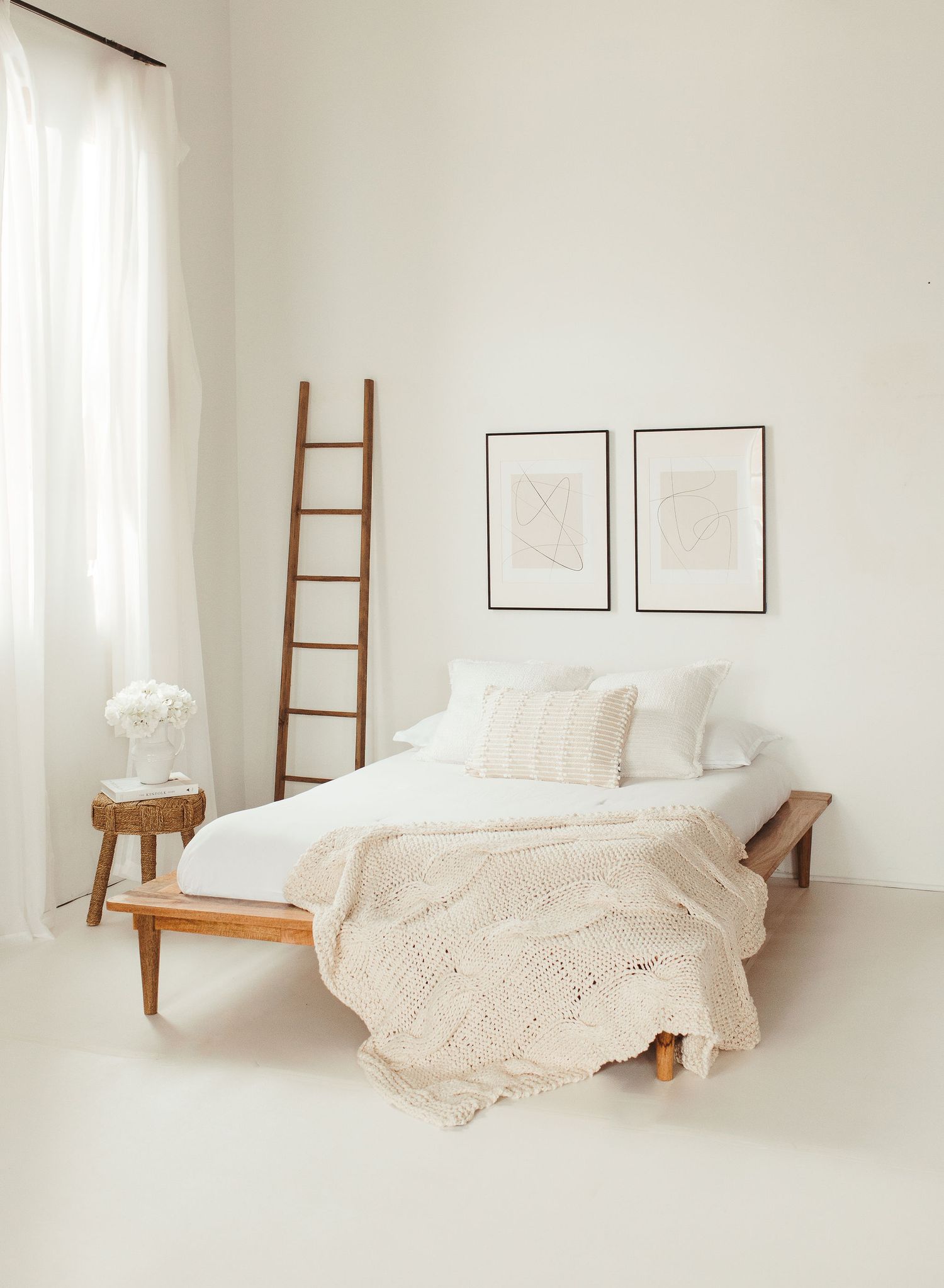Minimalist white bedroom series showing a wooden ladder and bed with cream bedding in various compositions.
