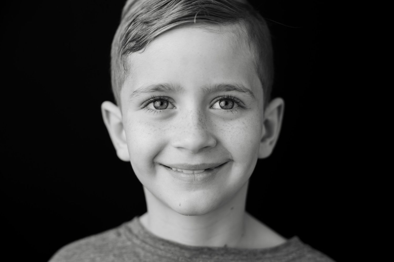 Black and white studio portraits showing genuine emotions and candid expressions.