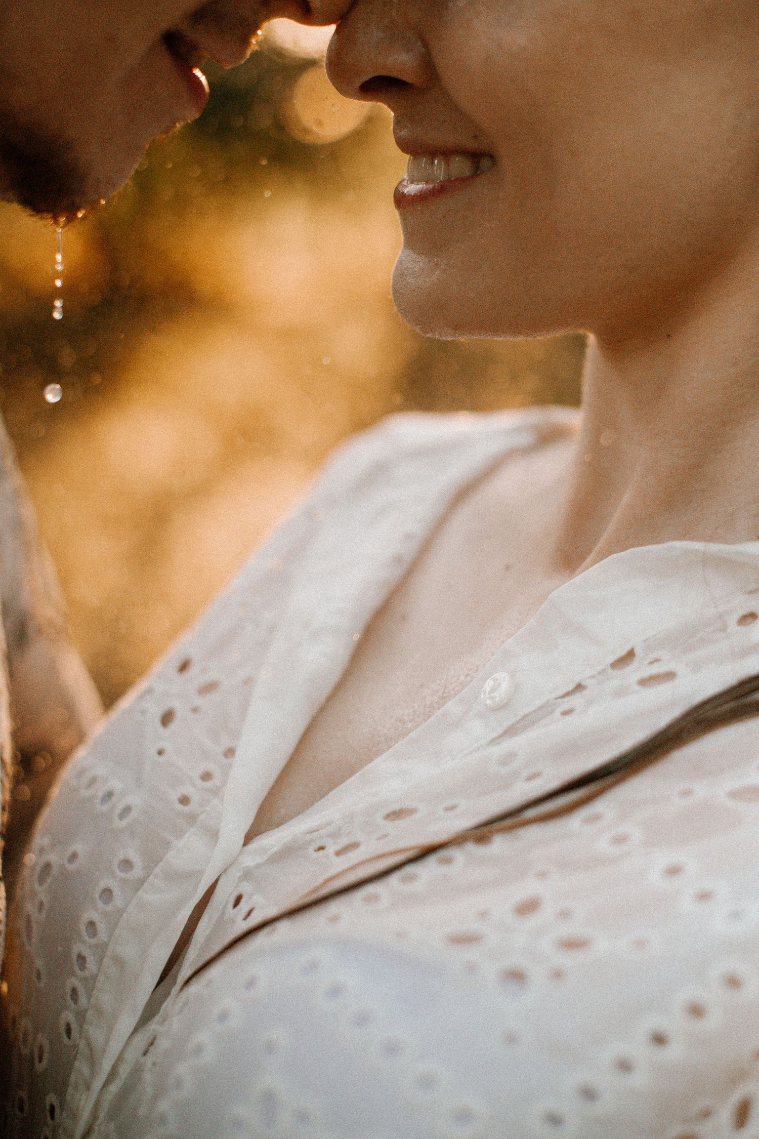 Intimate close-up portrait with soft golden bokeh background.