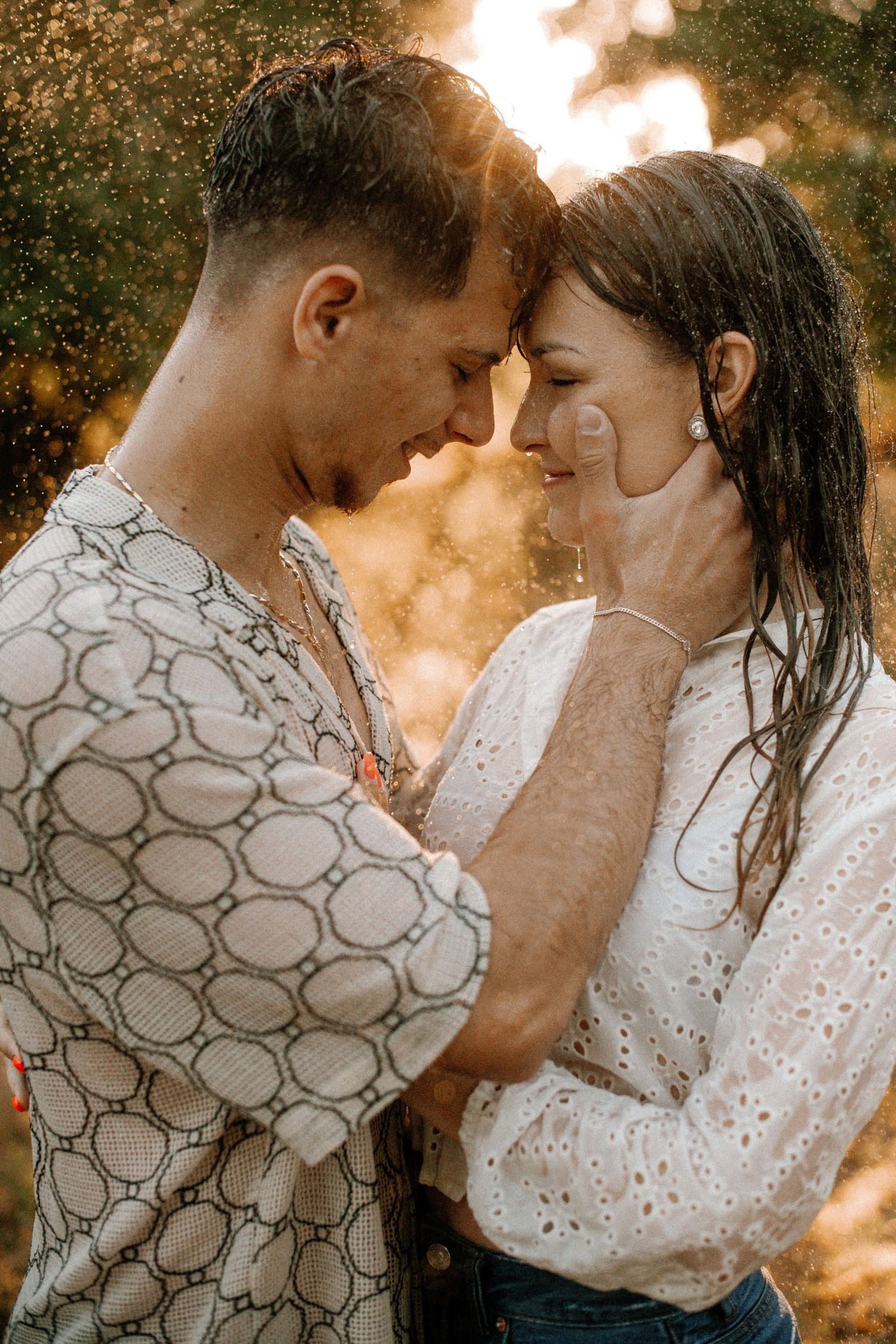 Intimate moment shared between couple in warm sunset light.