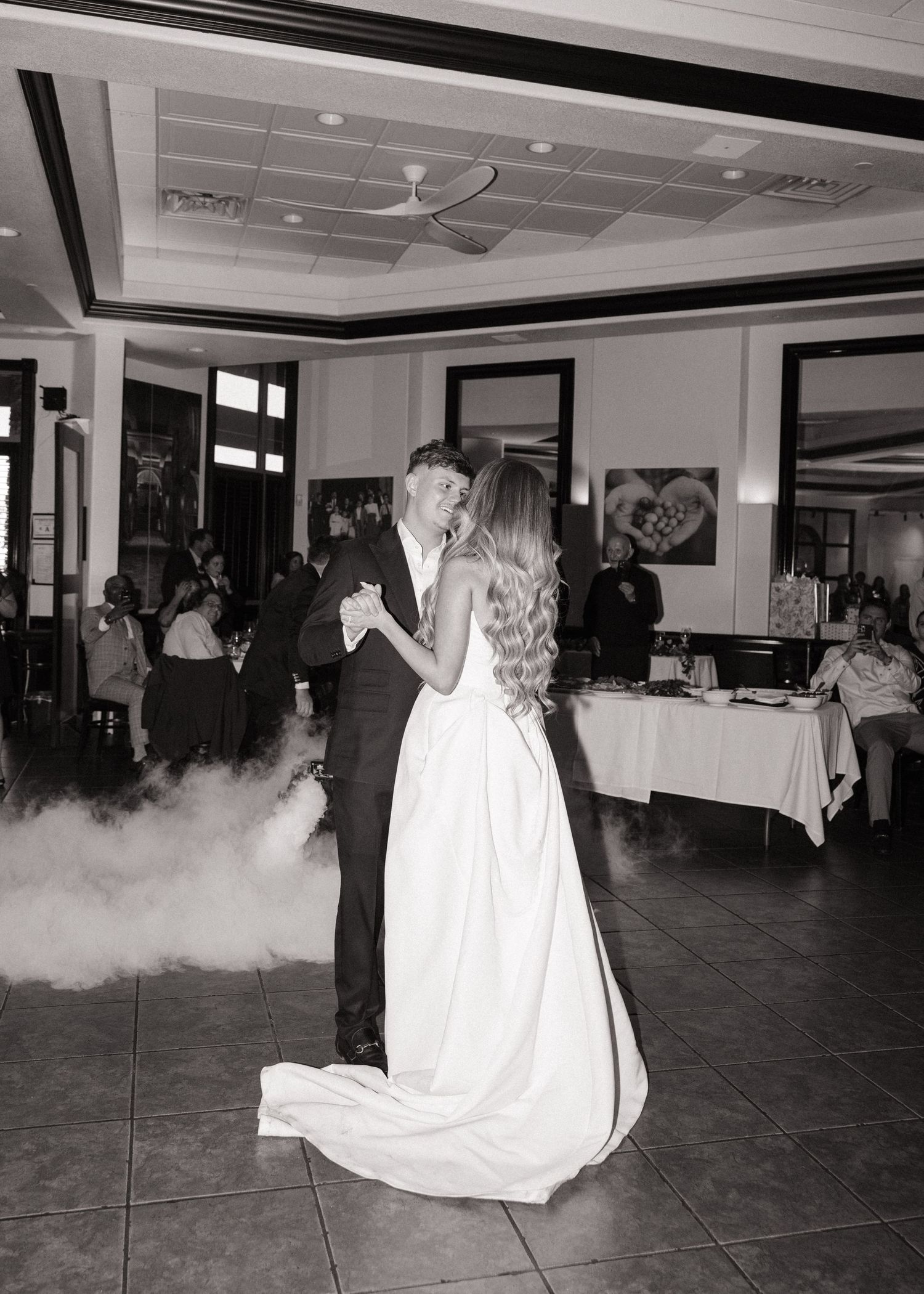 A romantic first dance with fog effects on a reception dance floor.