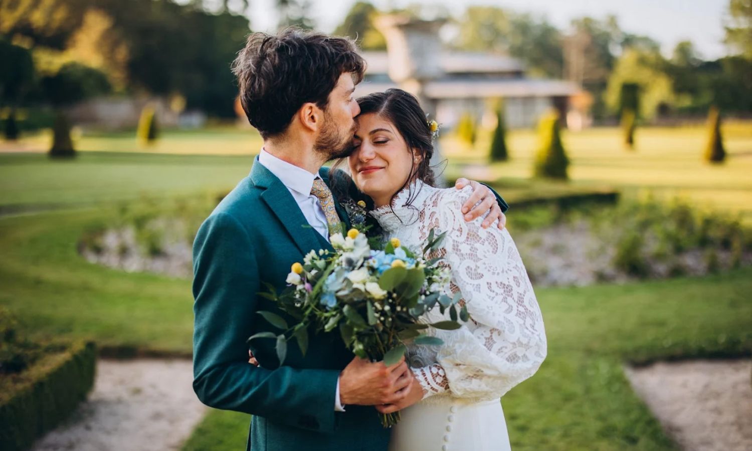 A romantic outdoor wedding photoshoot at sunset in a scenic garden setting with elegant floral arrangements.