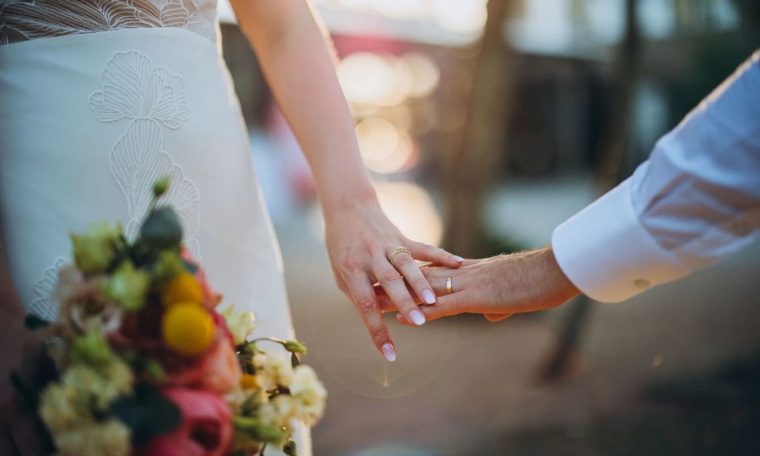 Wedding guests clink champagne glasses together in celebration during an elegant reception toast.