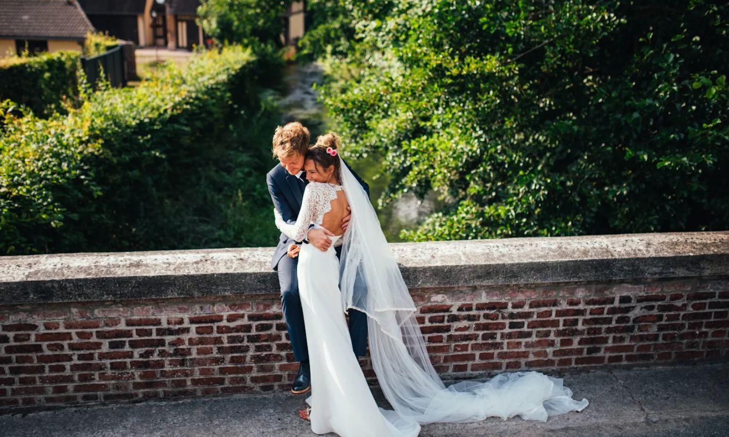 Romantic wedding couple shares intimate moments in a garden setting during their outdoor celebration.