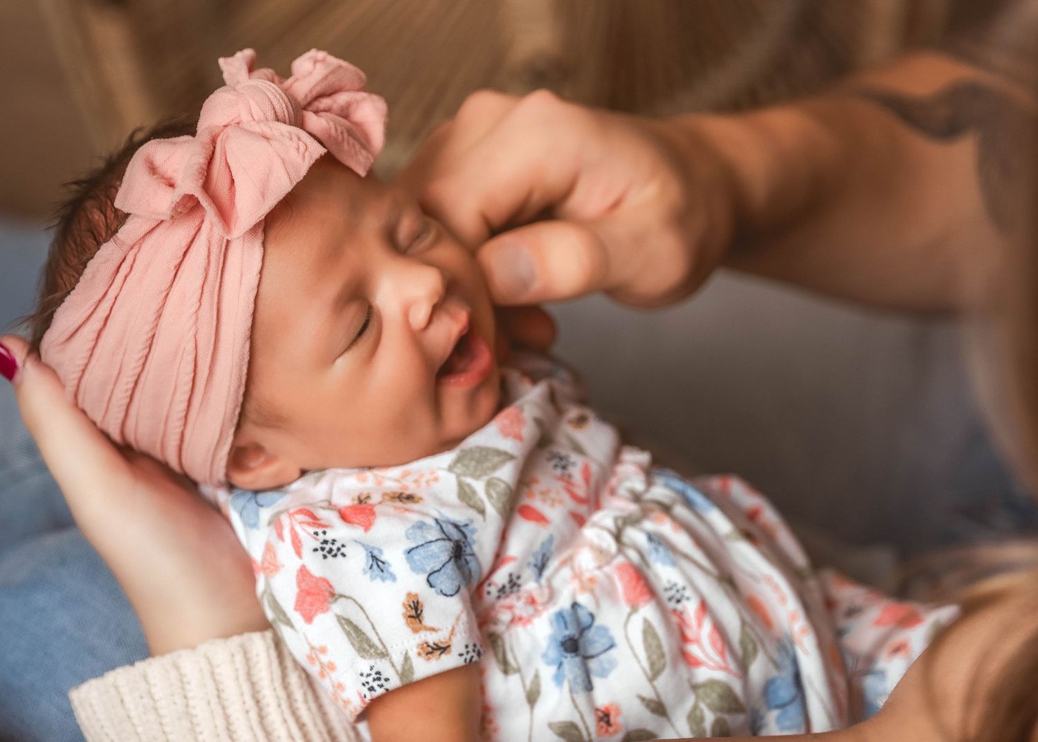 Father touching newborn baby's cheek during lifestyle newborn session in Central NY