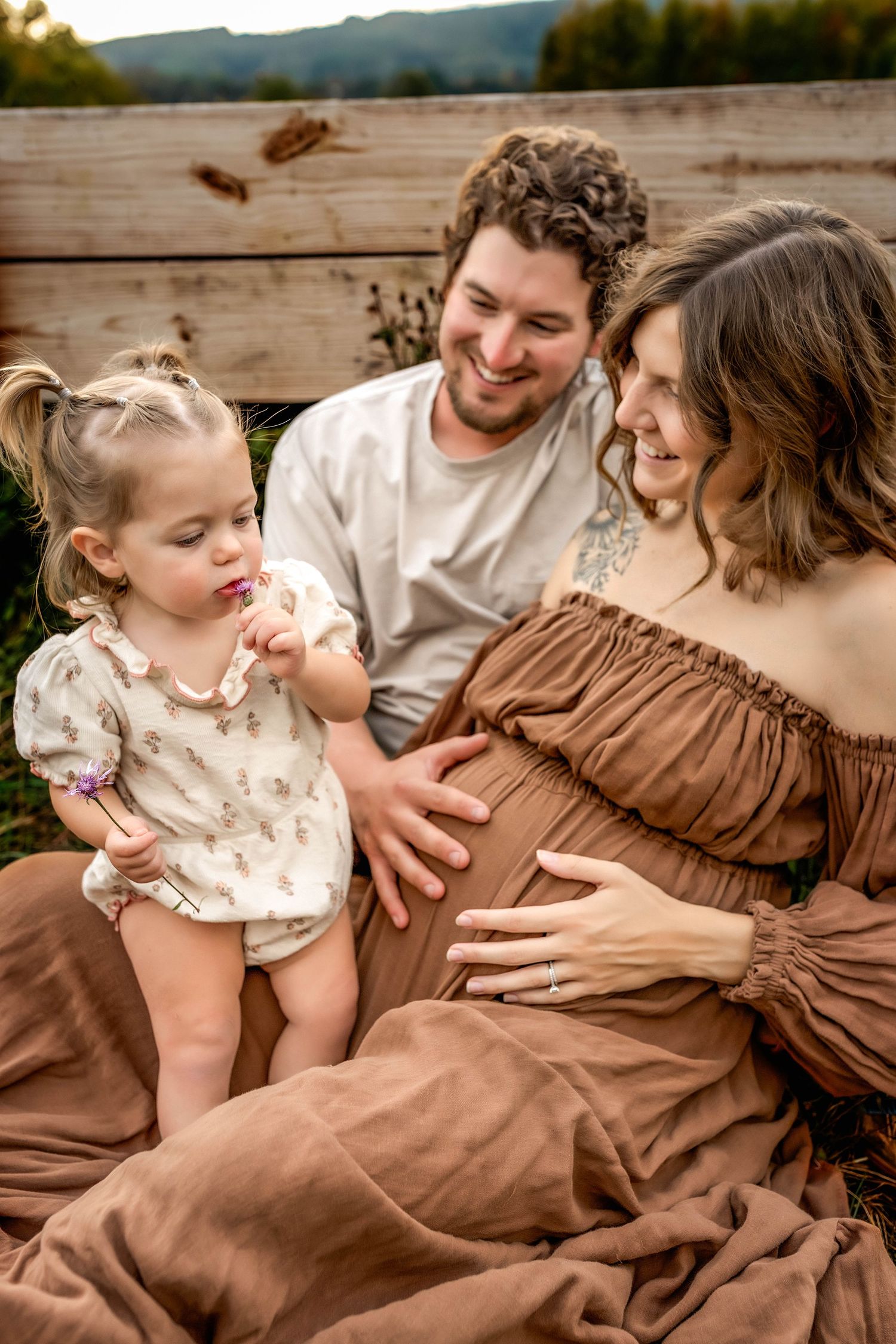 Family maternity photo with parents and toddler in a field in Central NY