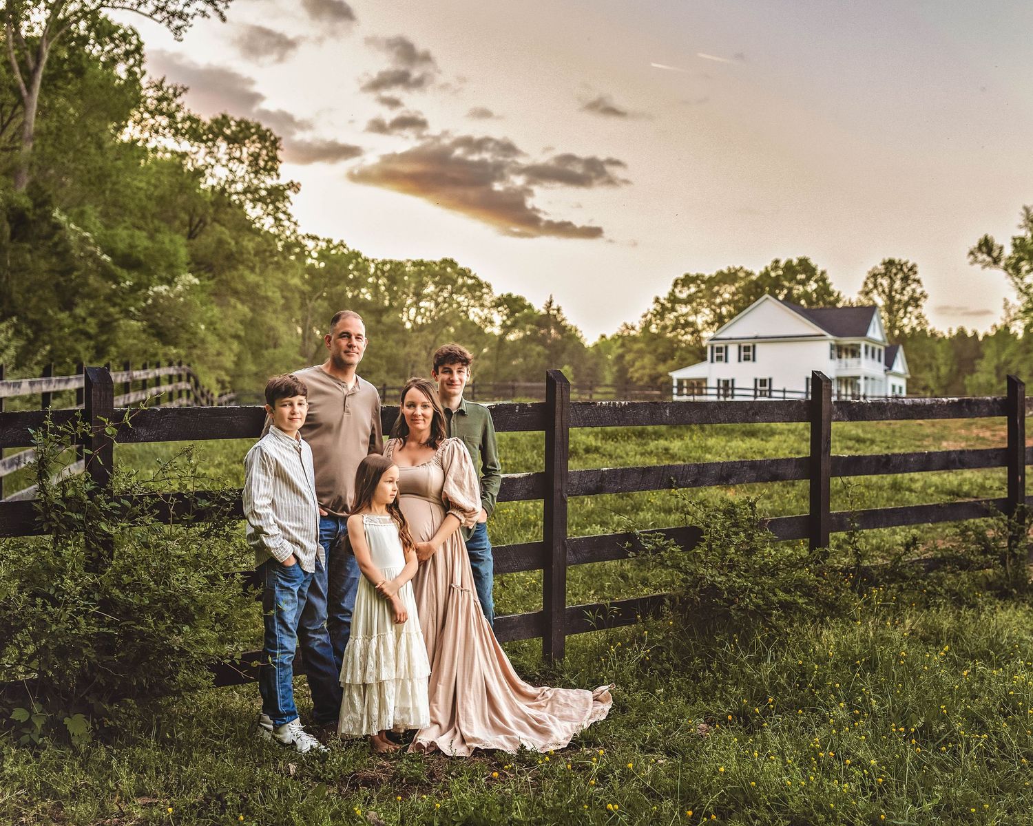 Family maternity session in front of fence in Central NY