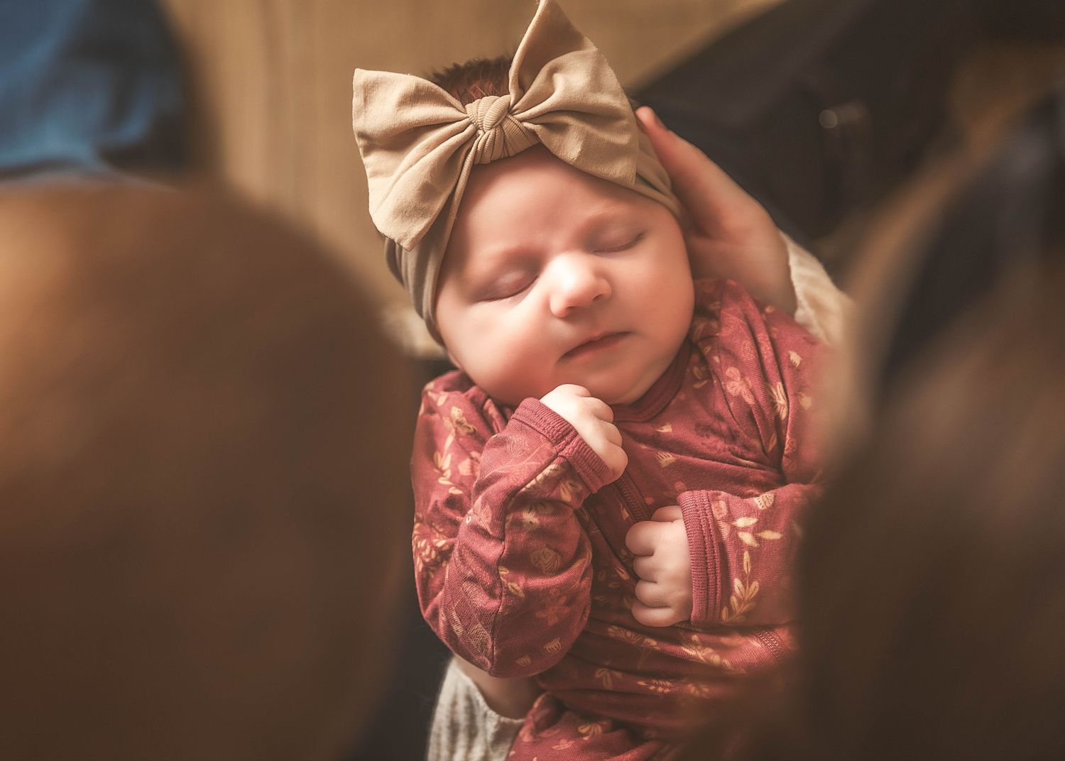 Newborn baby girl being held between parents during lifestyle newborn session in Central NY
