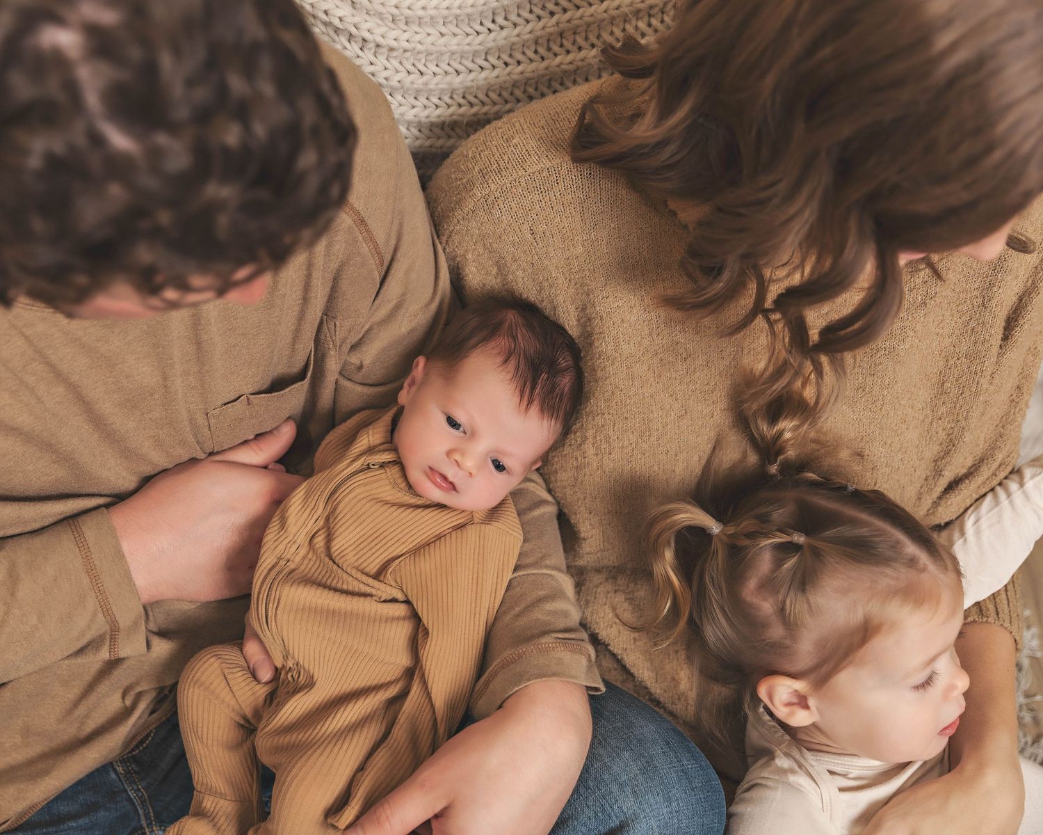 Parents and toddler sibling with newborn baby during lifestyle newborn session in Central NY