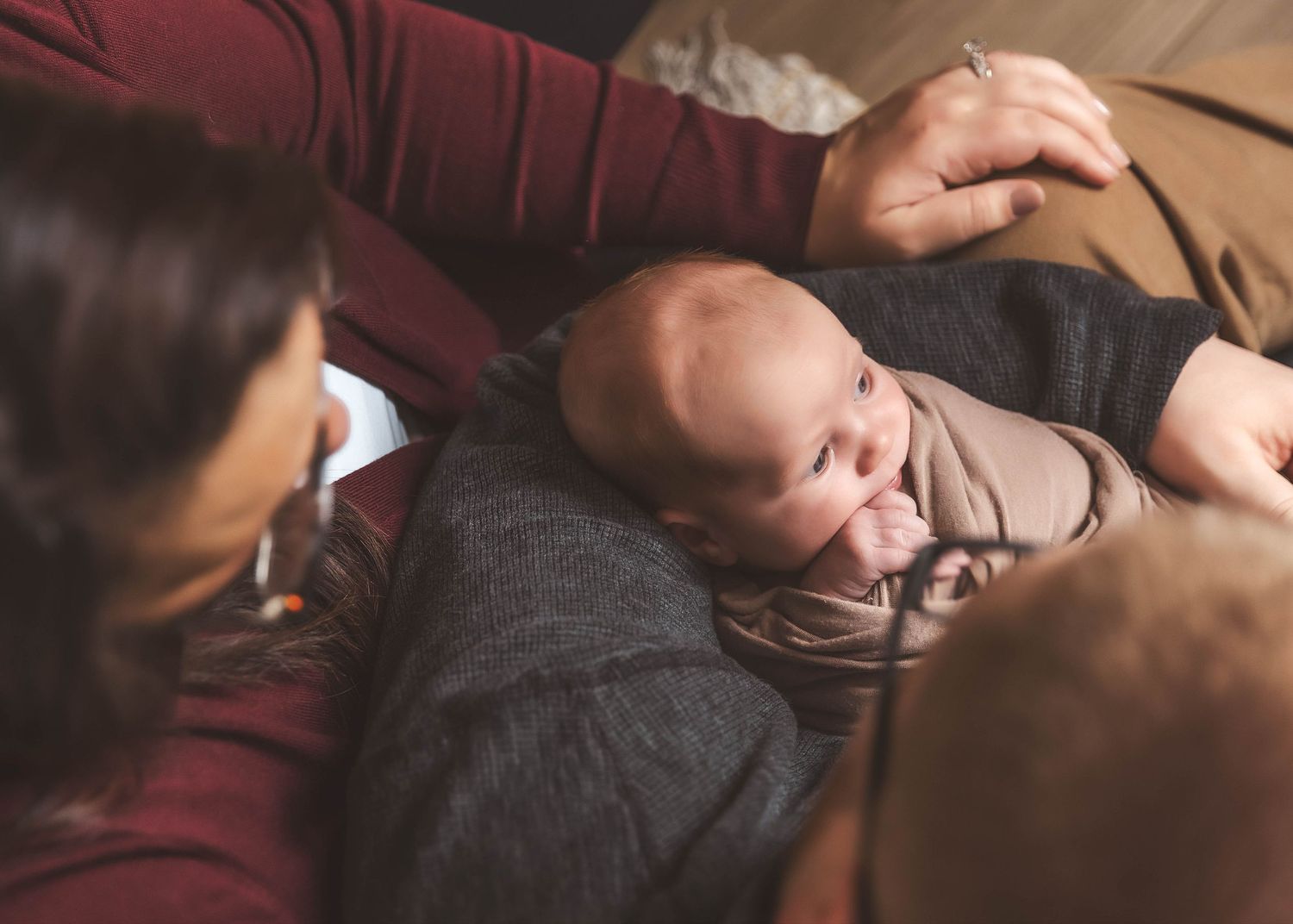 parents holding baby during lifestyle newborn photos in Central NY