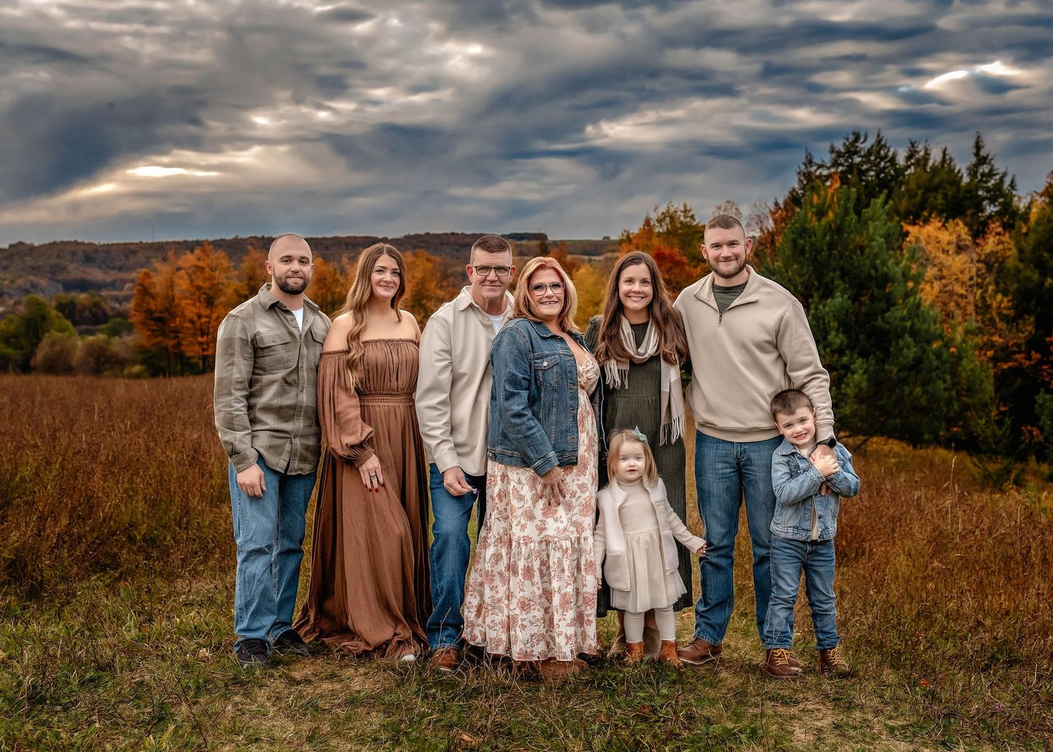 Styled Generational family photo in a field in Central NY with stormy sky