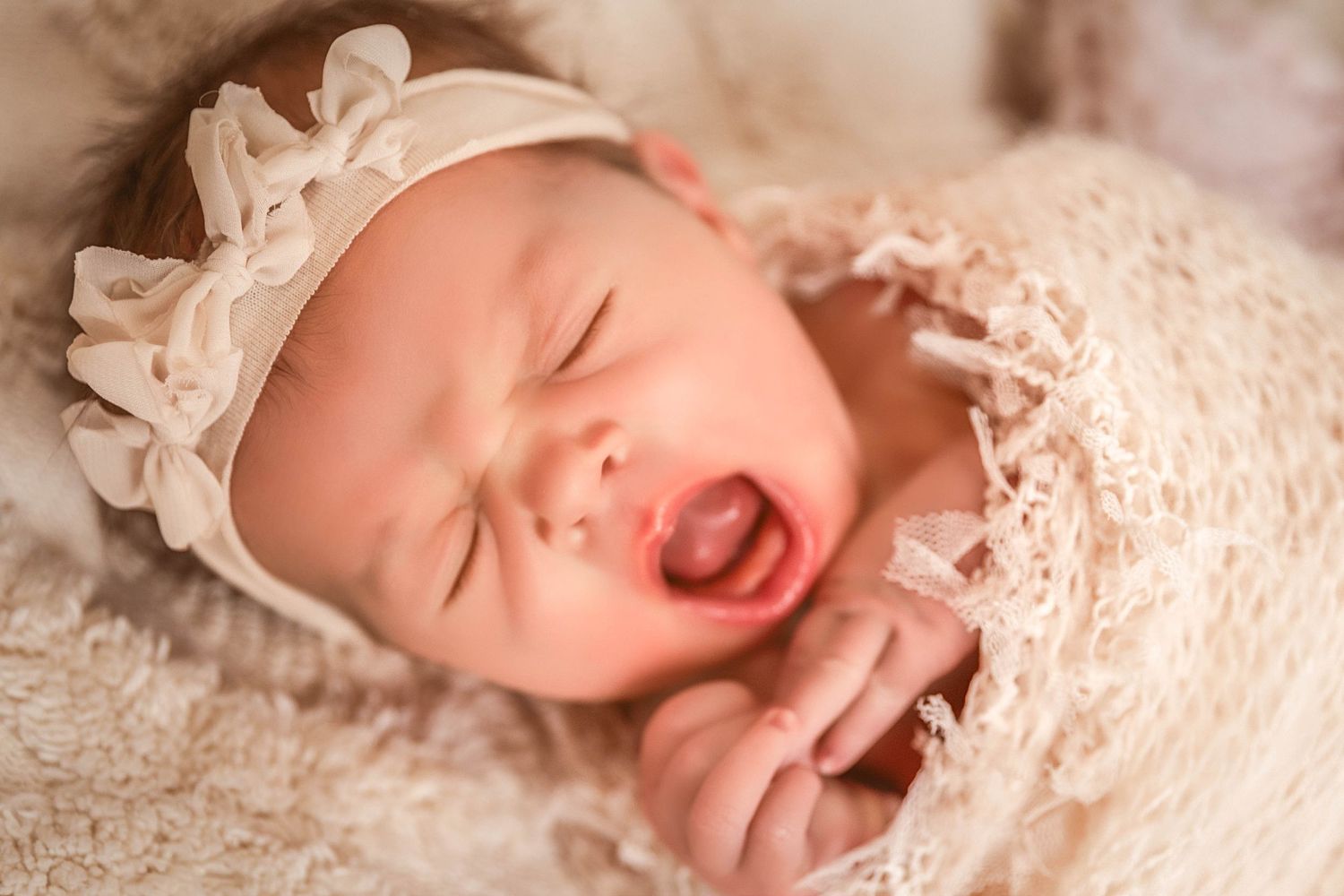 Newborn baby girl yawning during studio session in Central NY