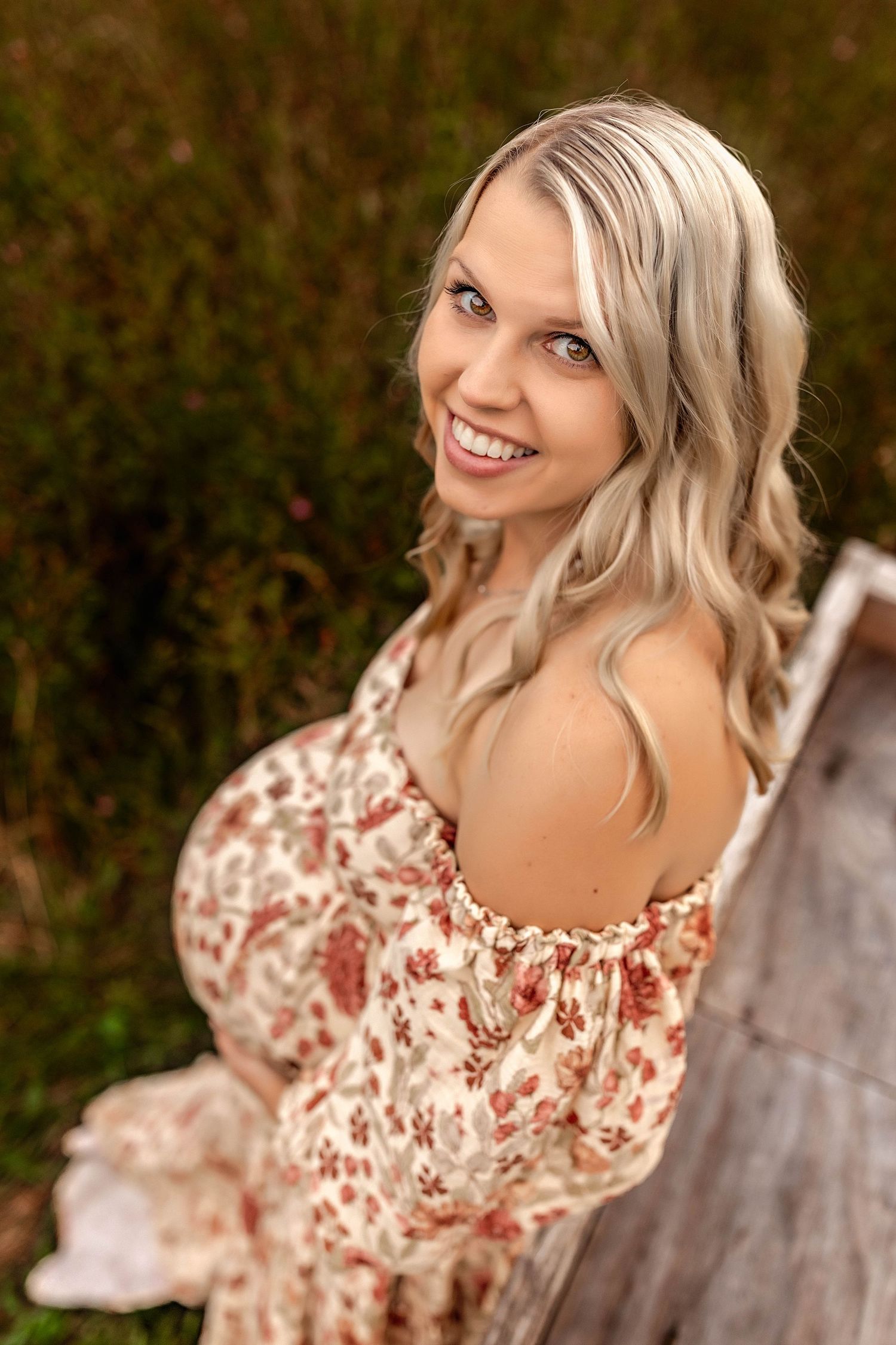Woman cradling her pregnant belly during maternity photos in Central NY