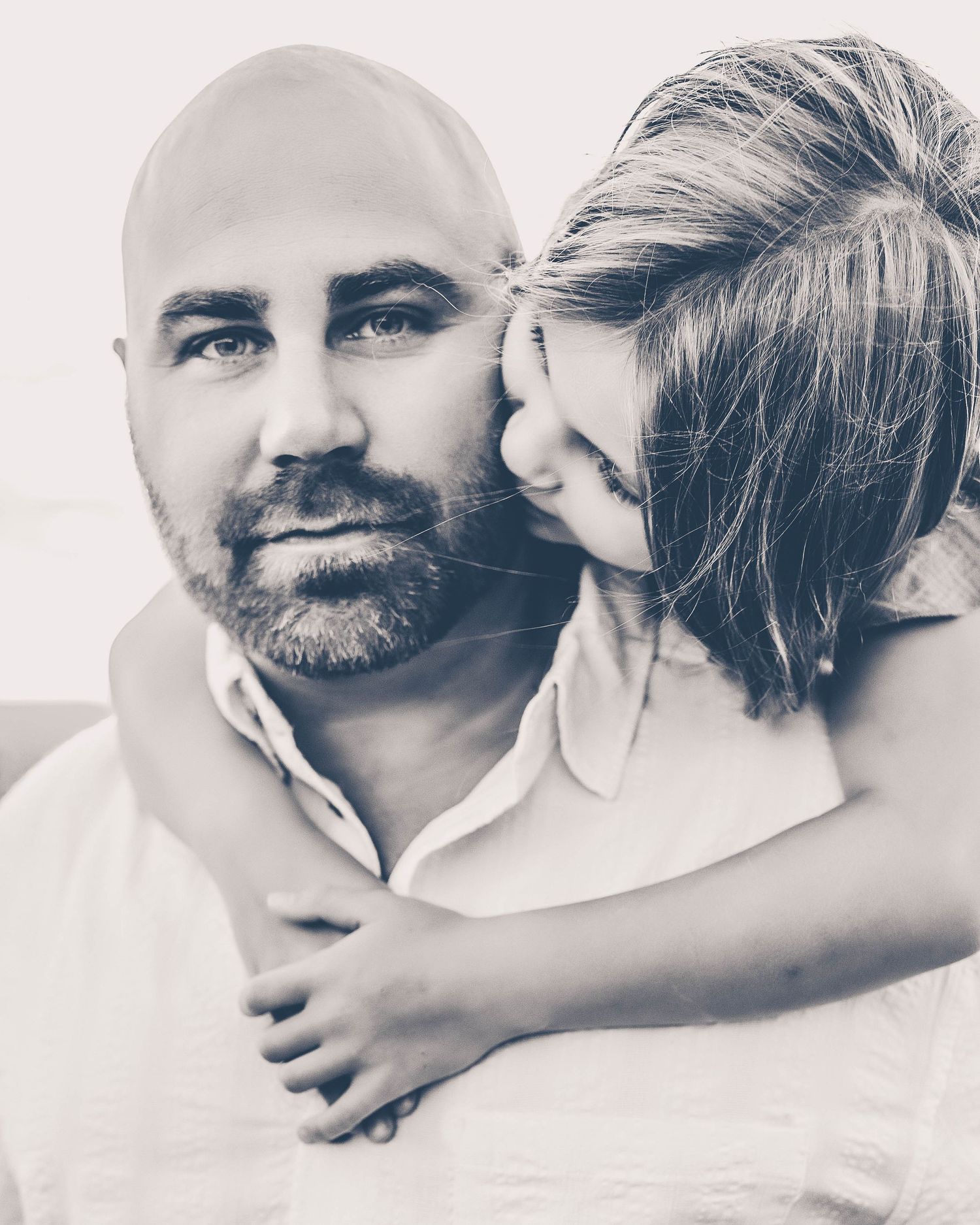 Daughter hugging dad in a country field setting