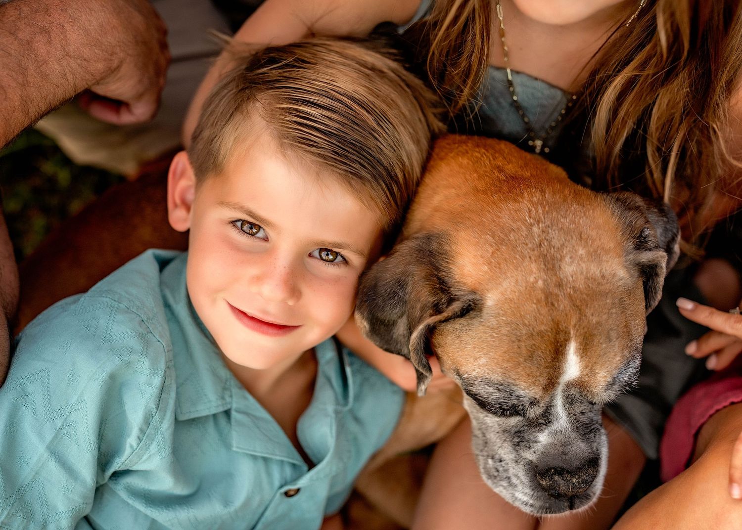 Boy and his dog snuggling for photo in Central NY